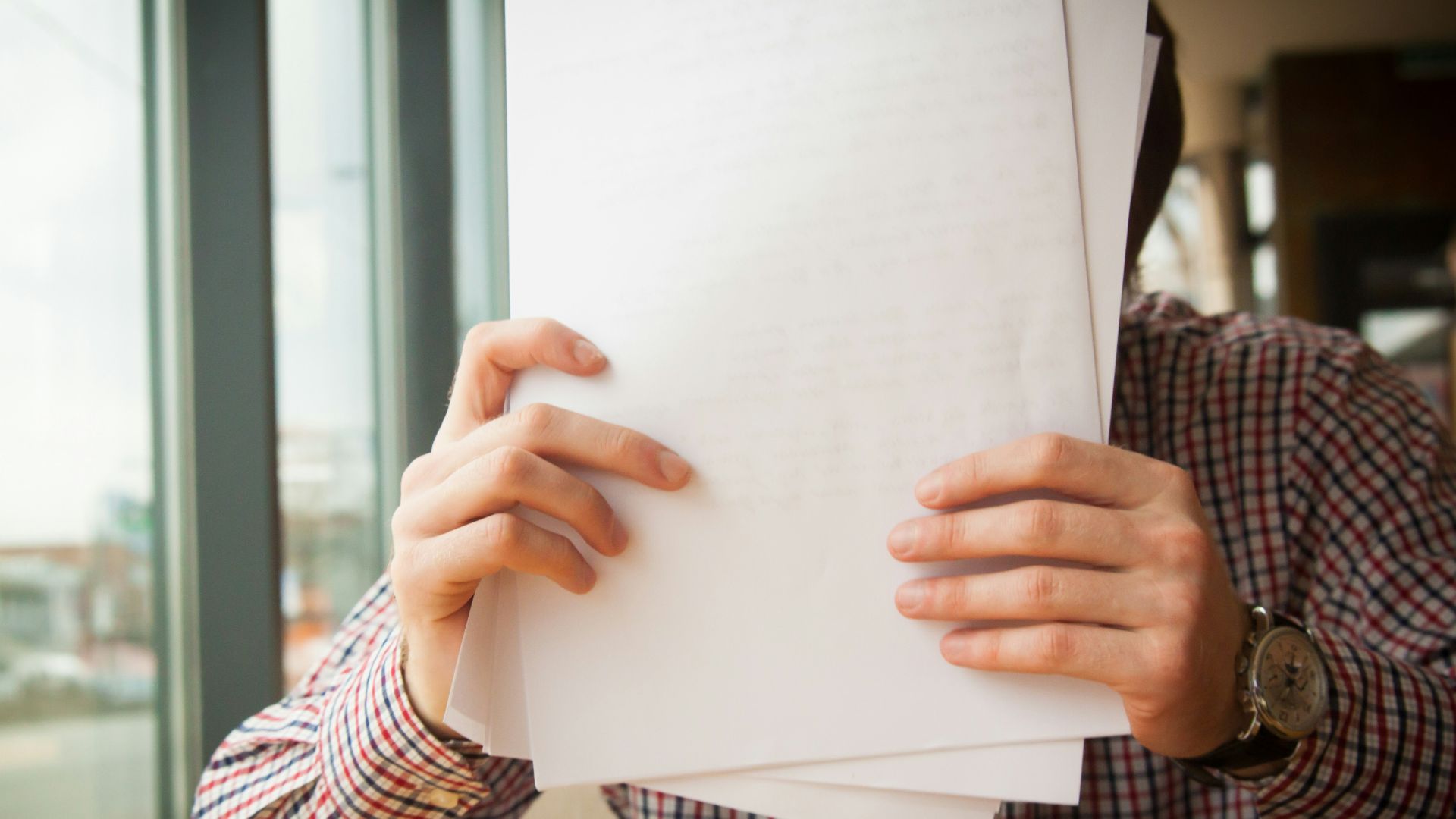 person holding white printer paper