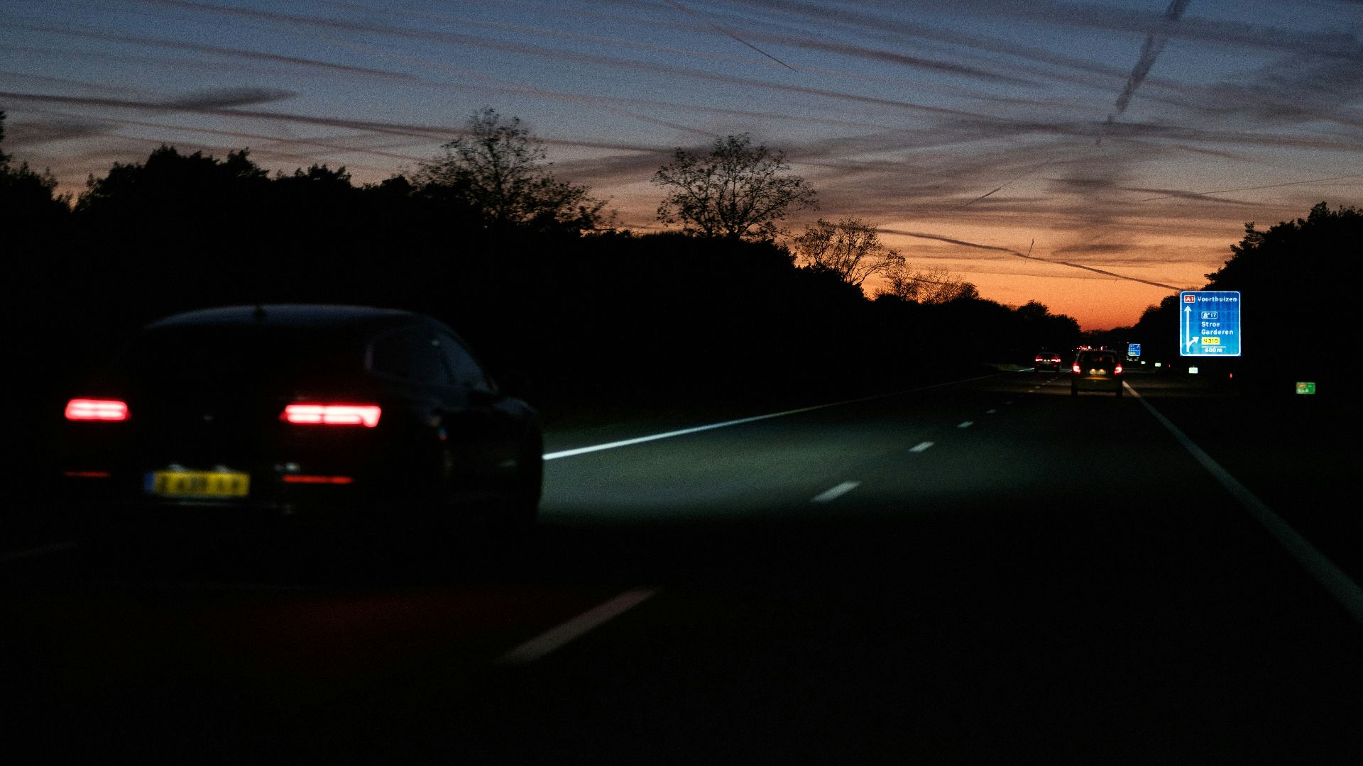 A car driving down a road at night