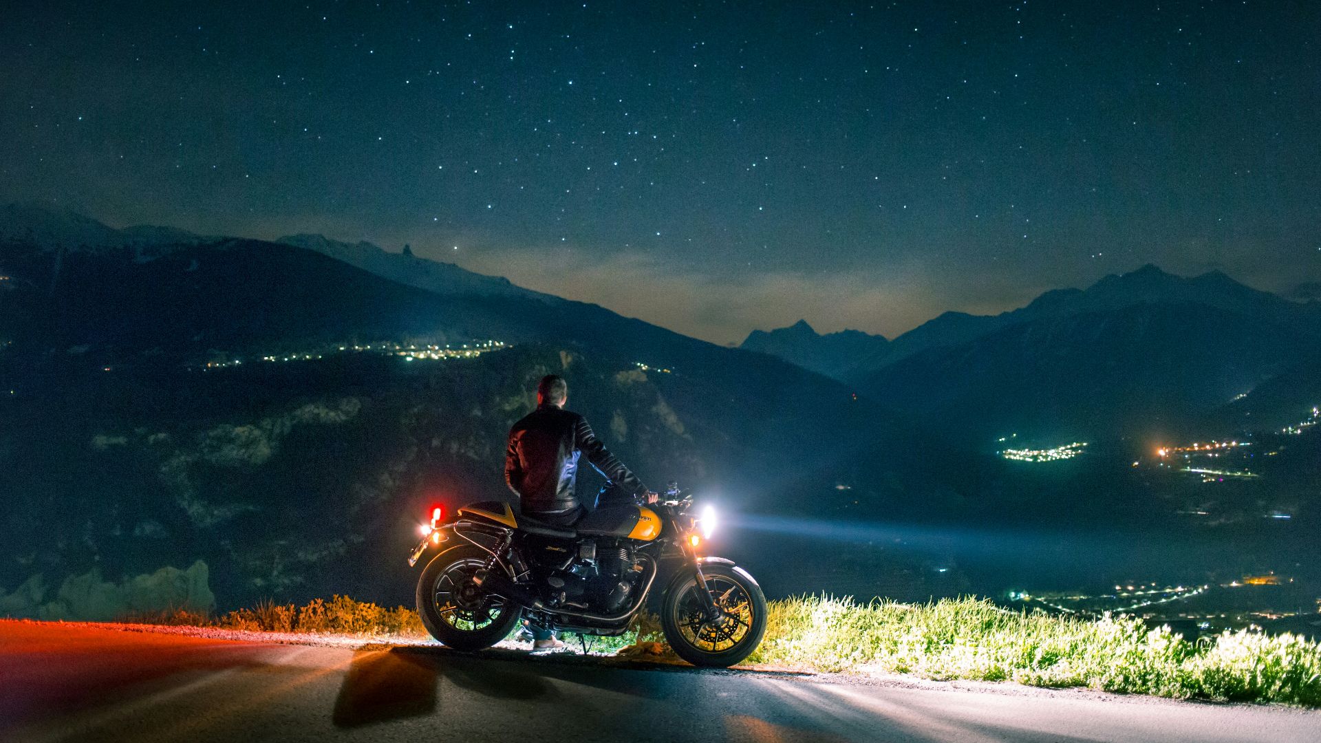man siting on motorcycle at night