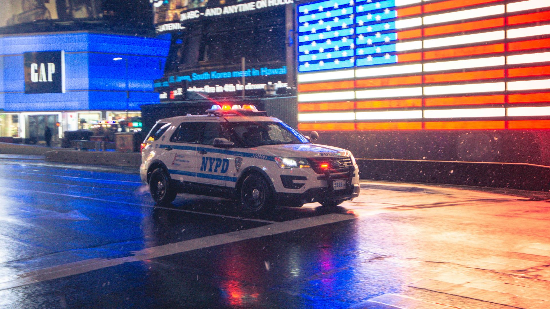 a police car driving down a city street at night