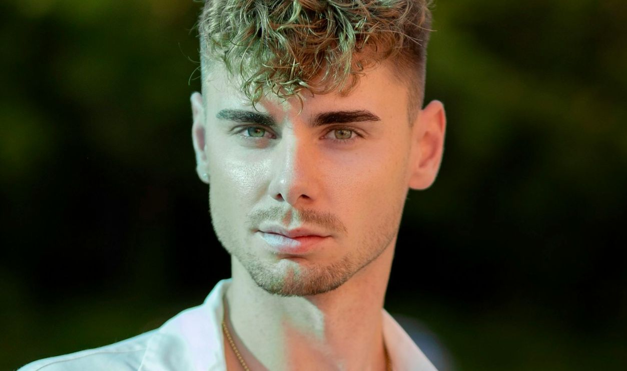 Photo of a Young Man Wearing a White Shirt