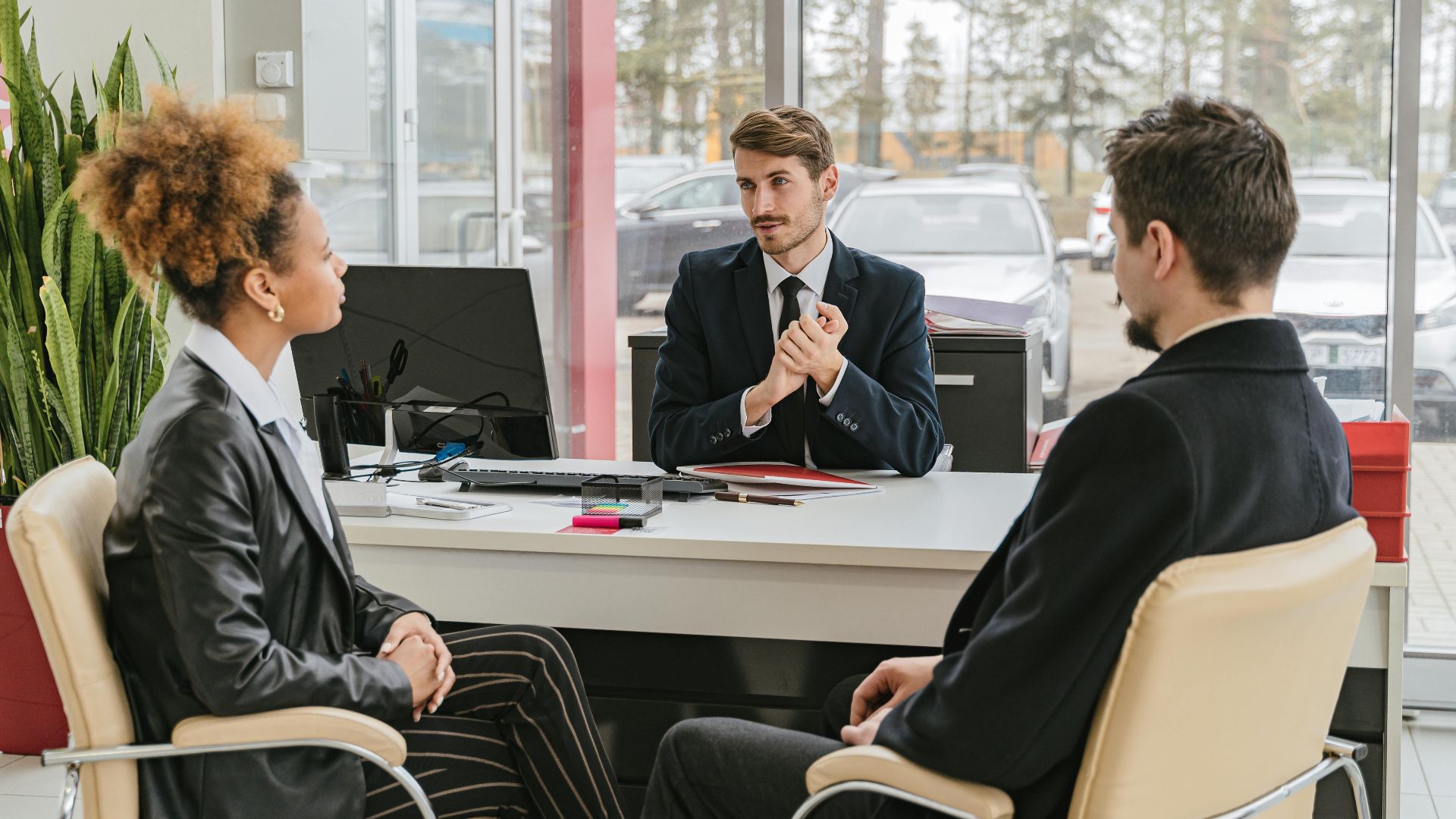 Professional meeting with clients at a modern office, discussing business solutions.