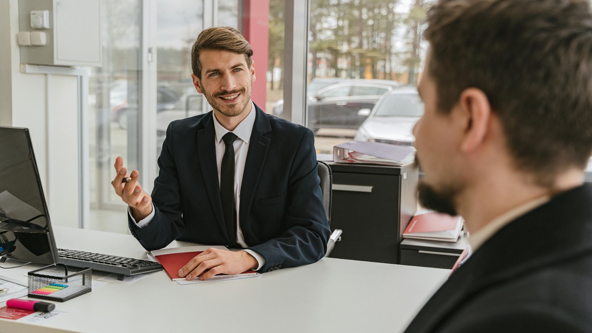 Two businessmen having a conversation in a modern office setting.