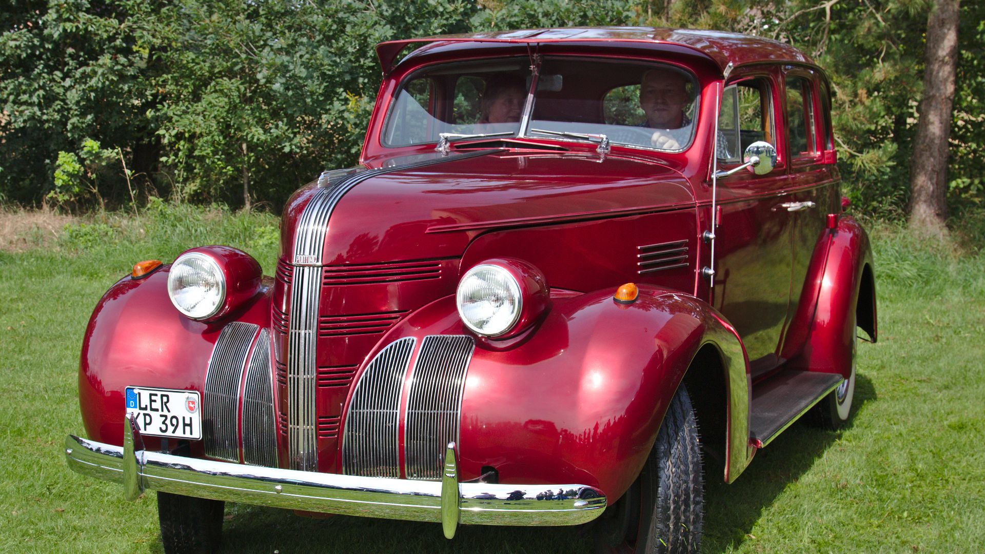 A Pontiac Deluxe Six 4-door sedan (type 26; built in 1939) on a vintage car show in Klein Scharrel village, Edewecht municipality, Lower Saxony, Germany, viewed from the front left side.
