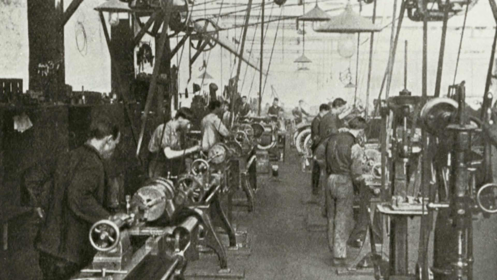 The inside of the Duncan and Fraser automotive factory, Franklin Street, Adelaide (north side), about 1915. Visible are lathes, other machinery, and motor vehicles in the background. The photo has been