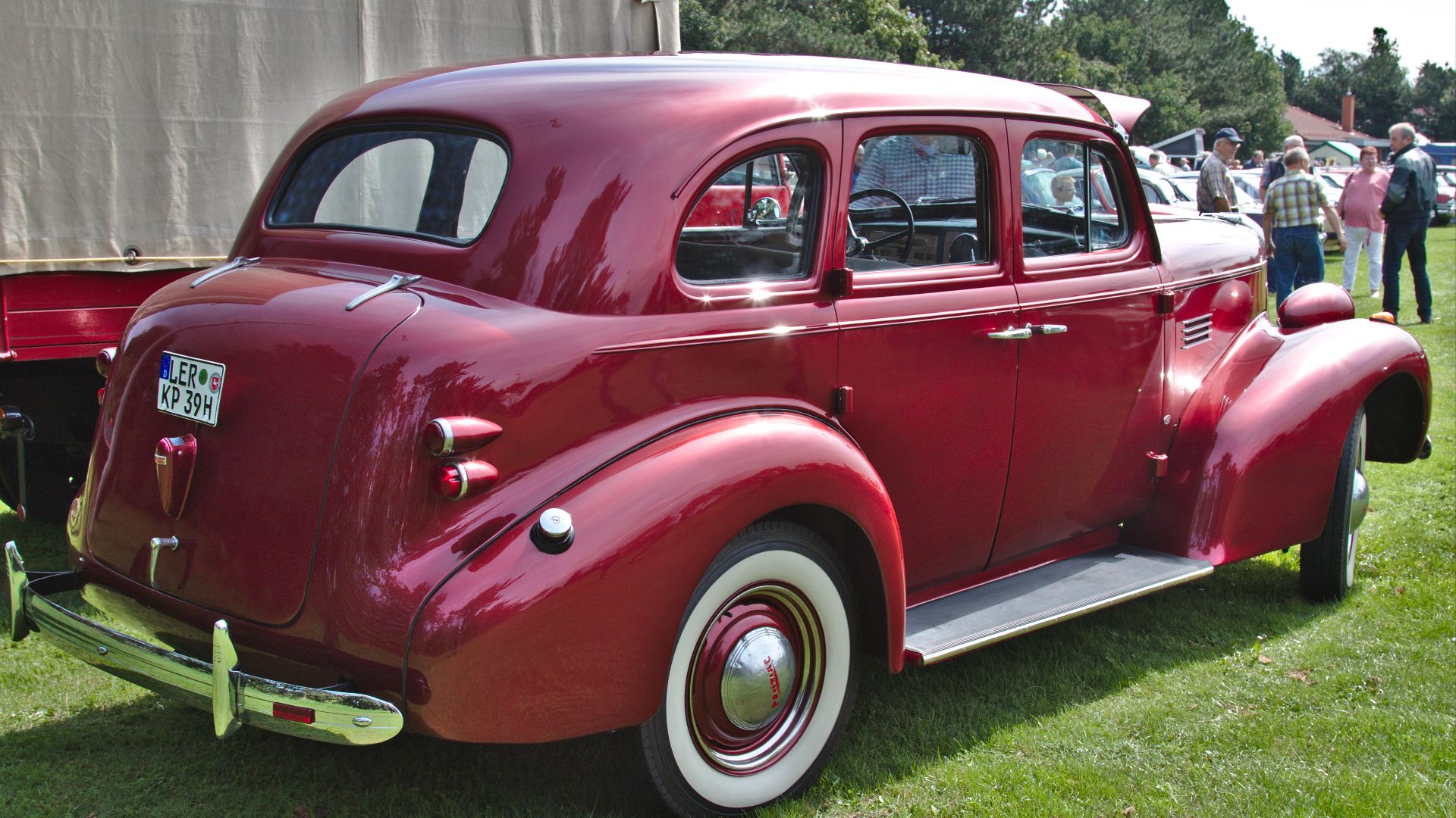 A Pontiac Deluxe Six 4-door sedan (type 26; built in 1939) on a vintage car show in Klein Scharrel village, Edewecht municipality, Lower Saxony, Germany, viewed from the rear right side.