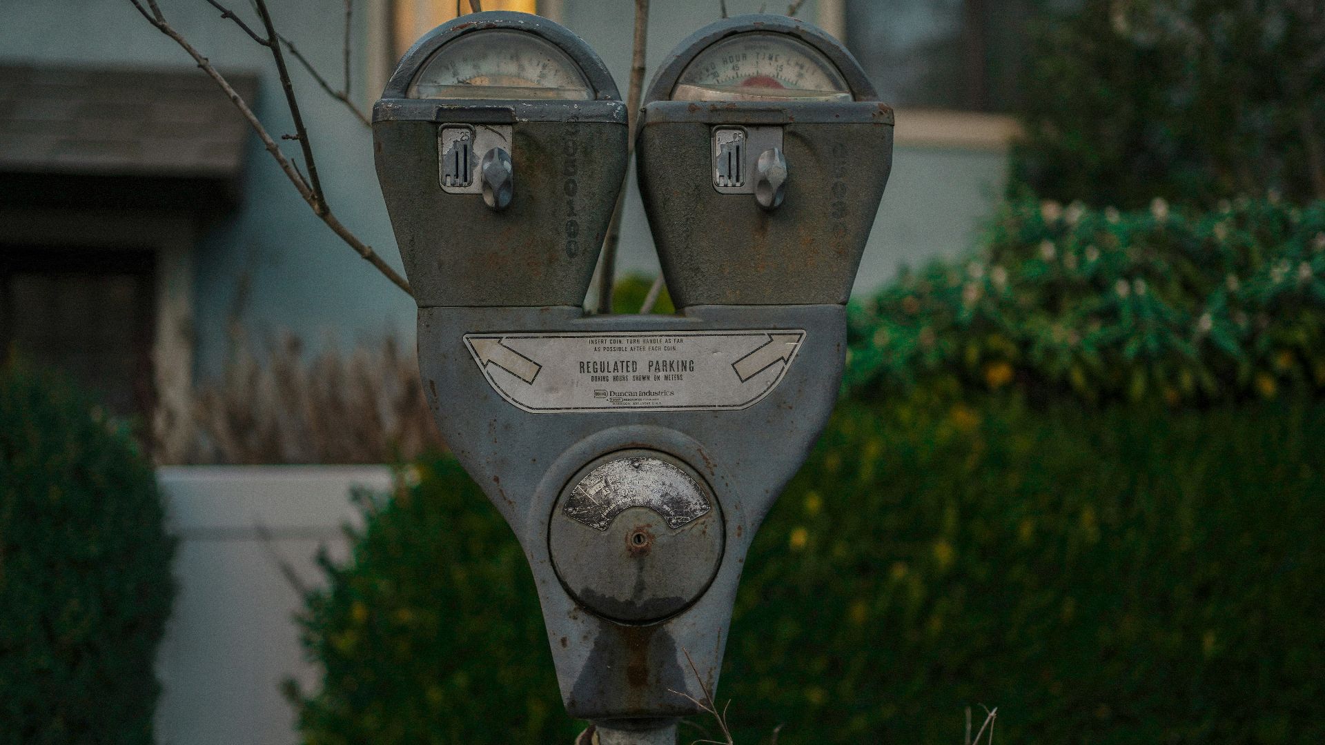 a parking meter in front of a house