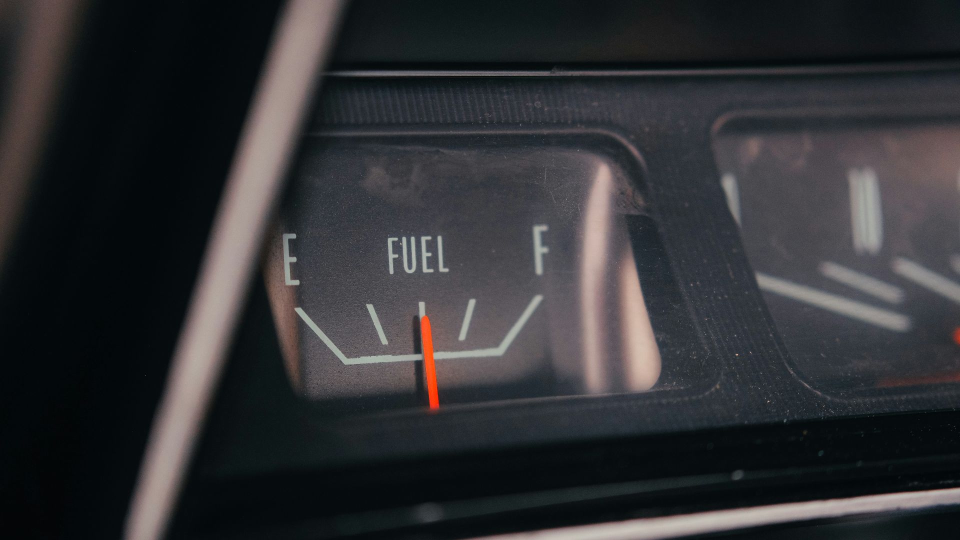Close-up of a car's fuel gauge showing empty