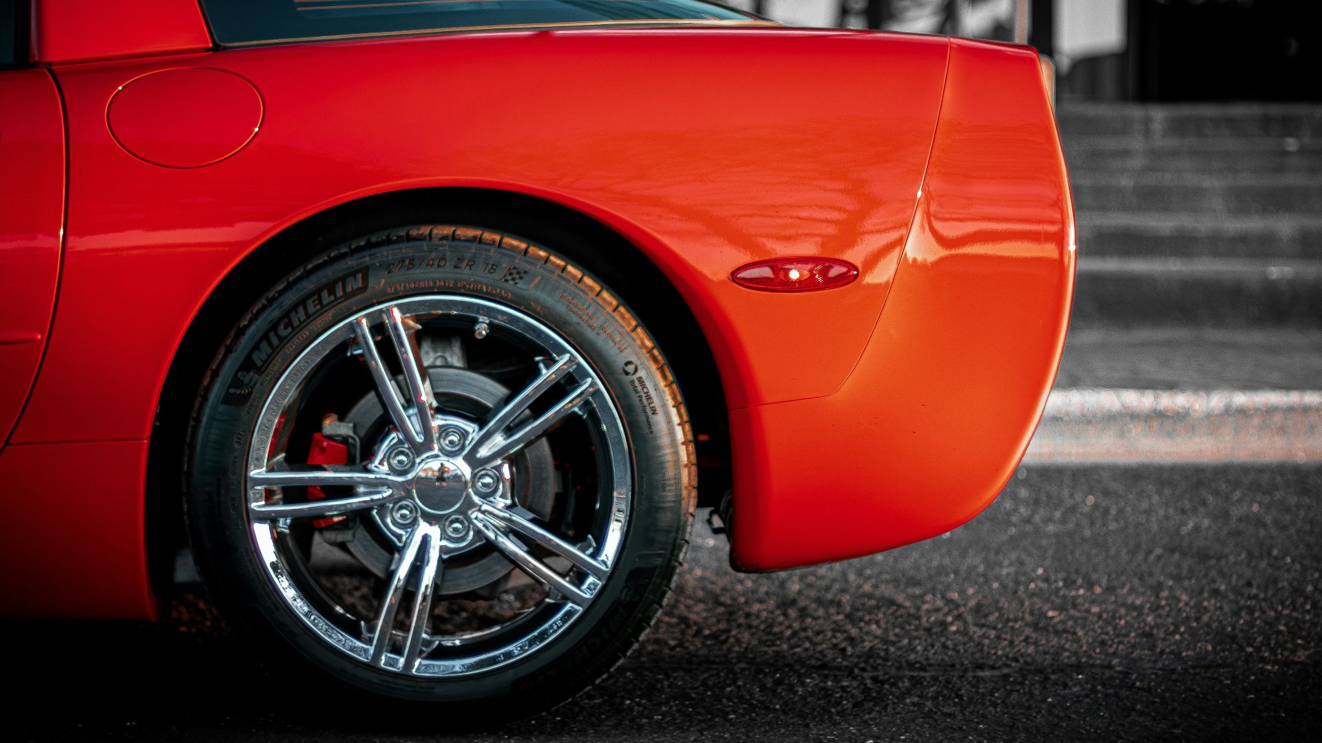 a red sports car parked in a parking lot