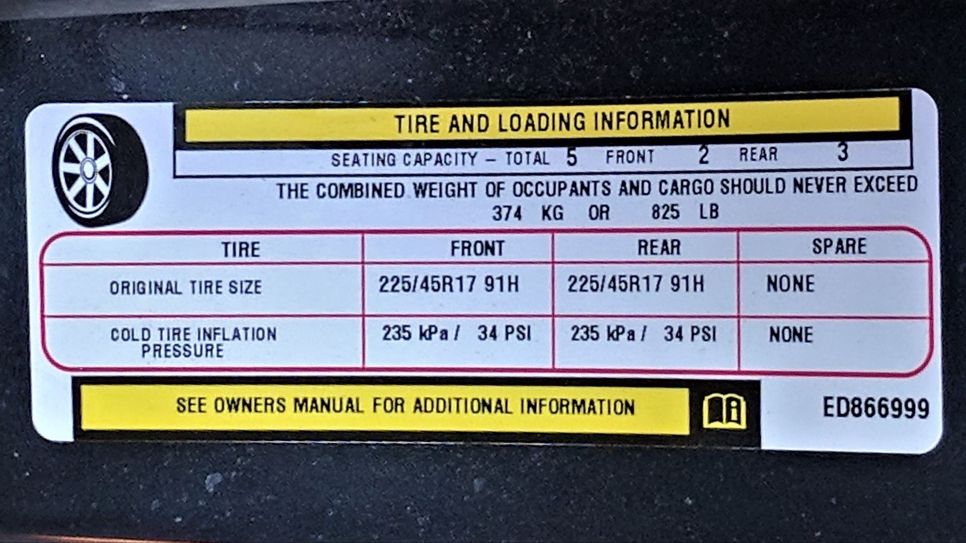 Information sticker on a Dodge Dart displaying the vehicles tire and load capacity.
