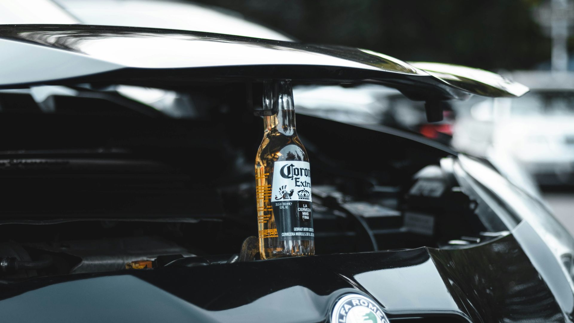clear glass bottle on black car