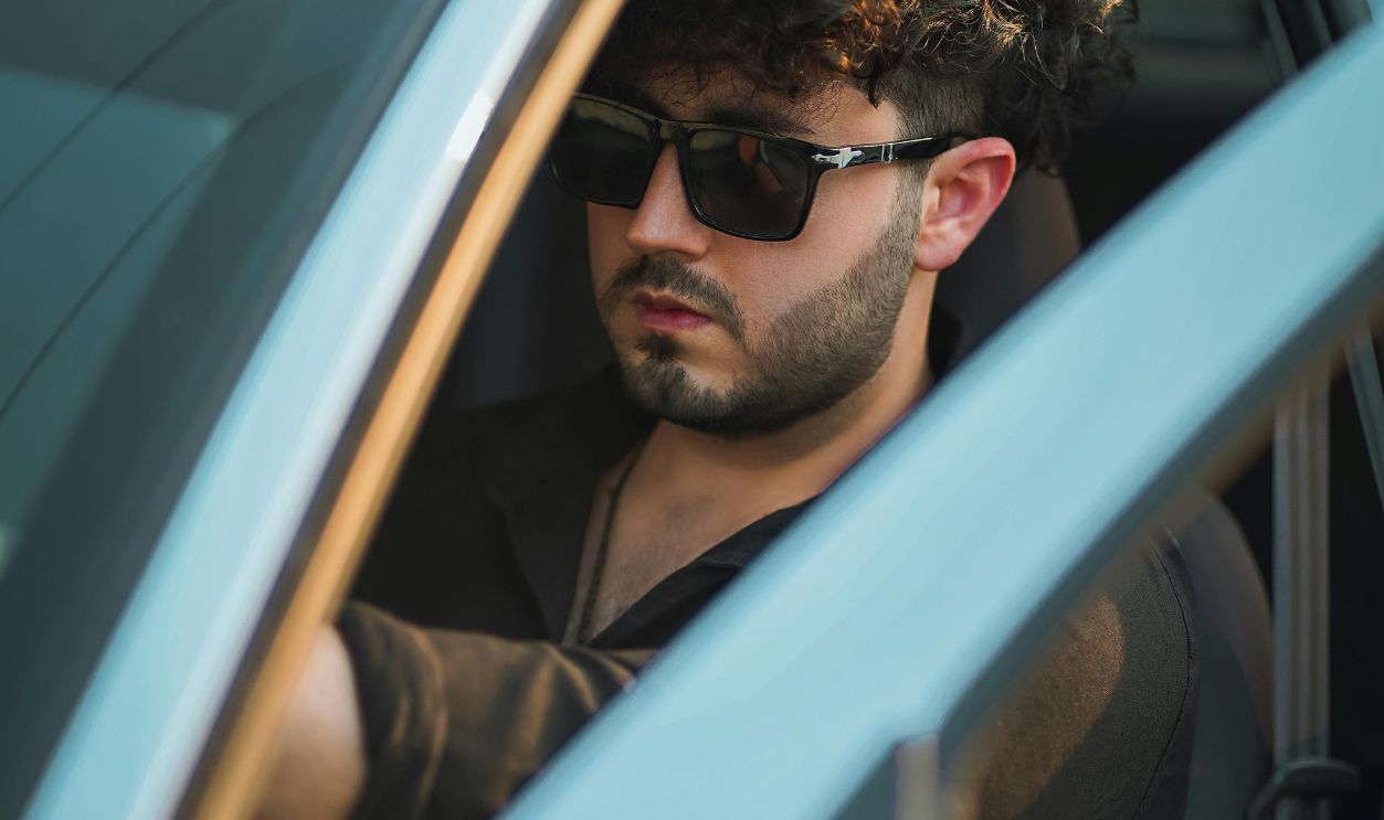 Man in Sunglasses in Blue Car