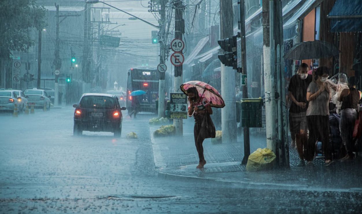 People Walking in Heavy Rain in City
