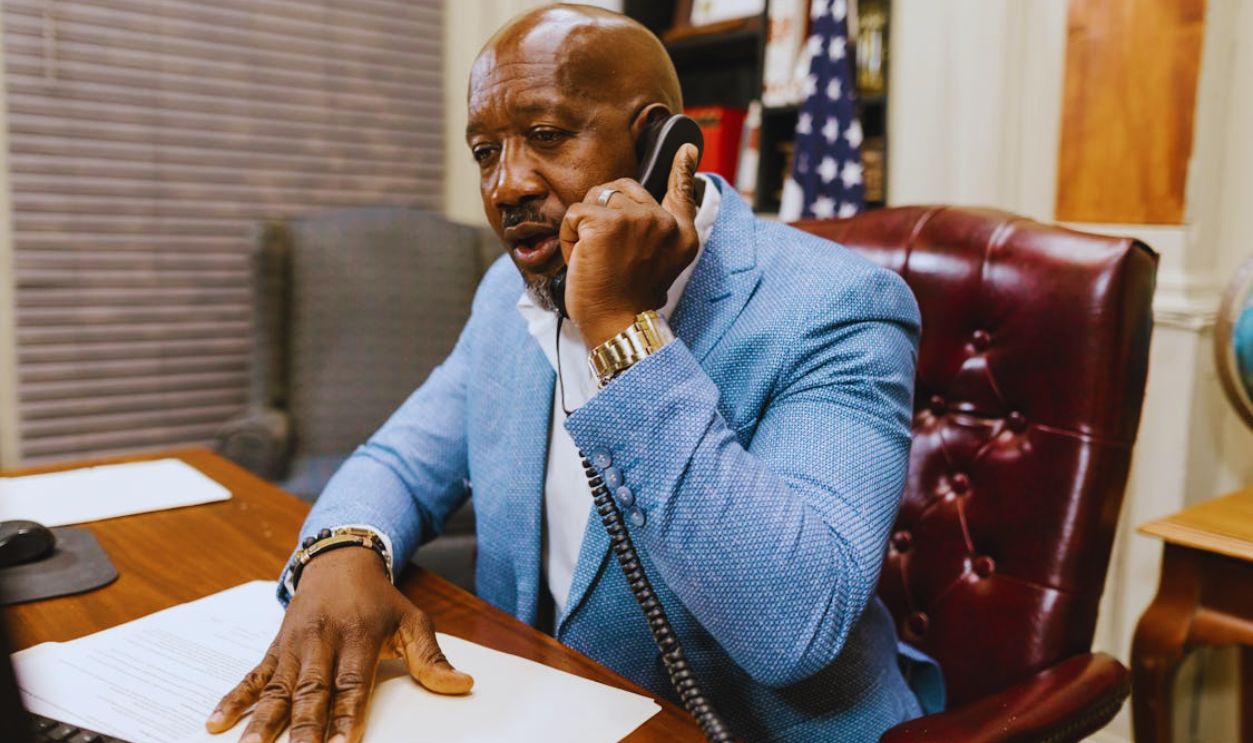 A Man using Telephone