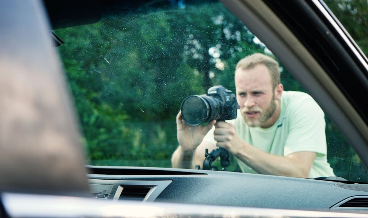 Man Taking Photo Near Vehicle