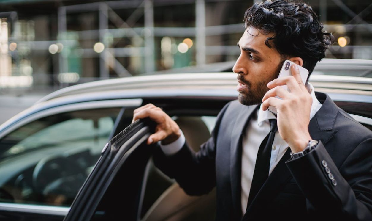 A Man in a Phone Call while Getting out of a Car