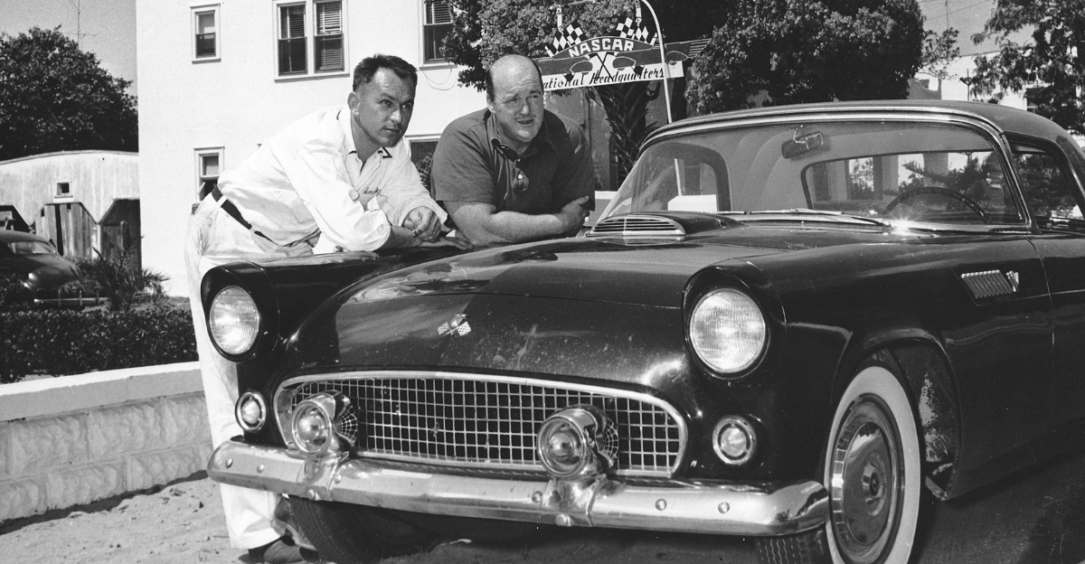 Master mechanic Smokey Yunick (L) poses with automotive journalist Tom McCahill next to a Ford Thunderbird