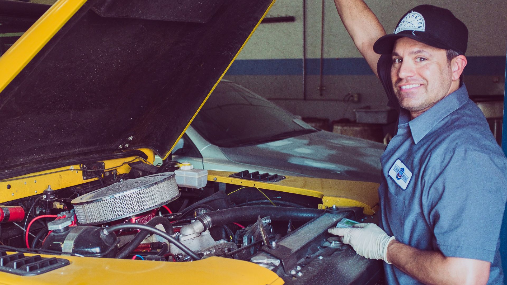 man holding open-wide car trunk