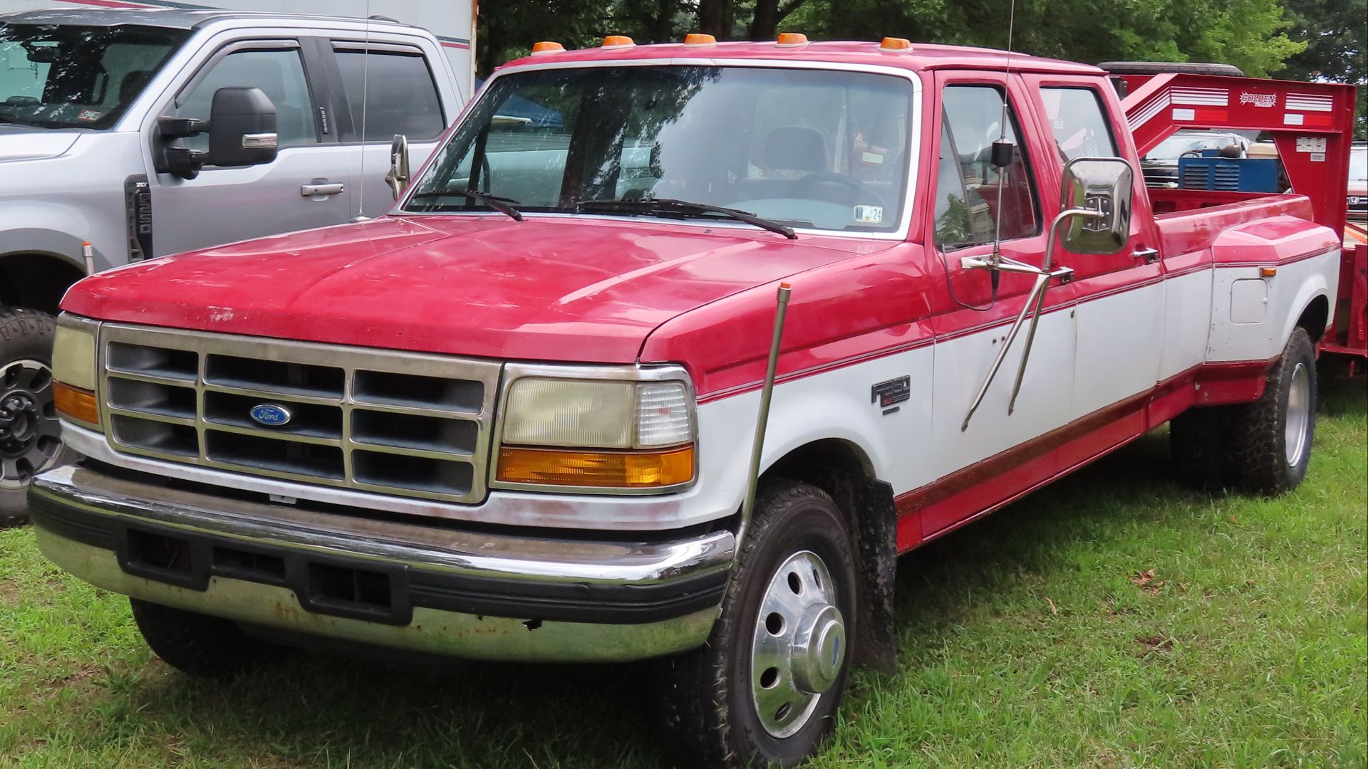 1994 Ford F-350 4x4 DRW XLT crew cab photographed in the parking area of the 2024 Portersville Summer Steam Show in Portersville, Pennsylvania. Finished in Bright Red over Oxford White.