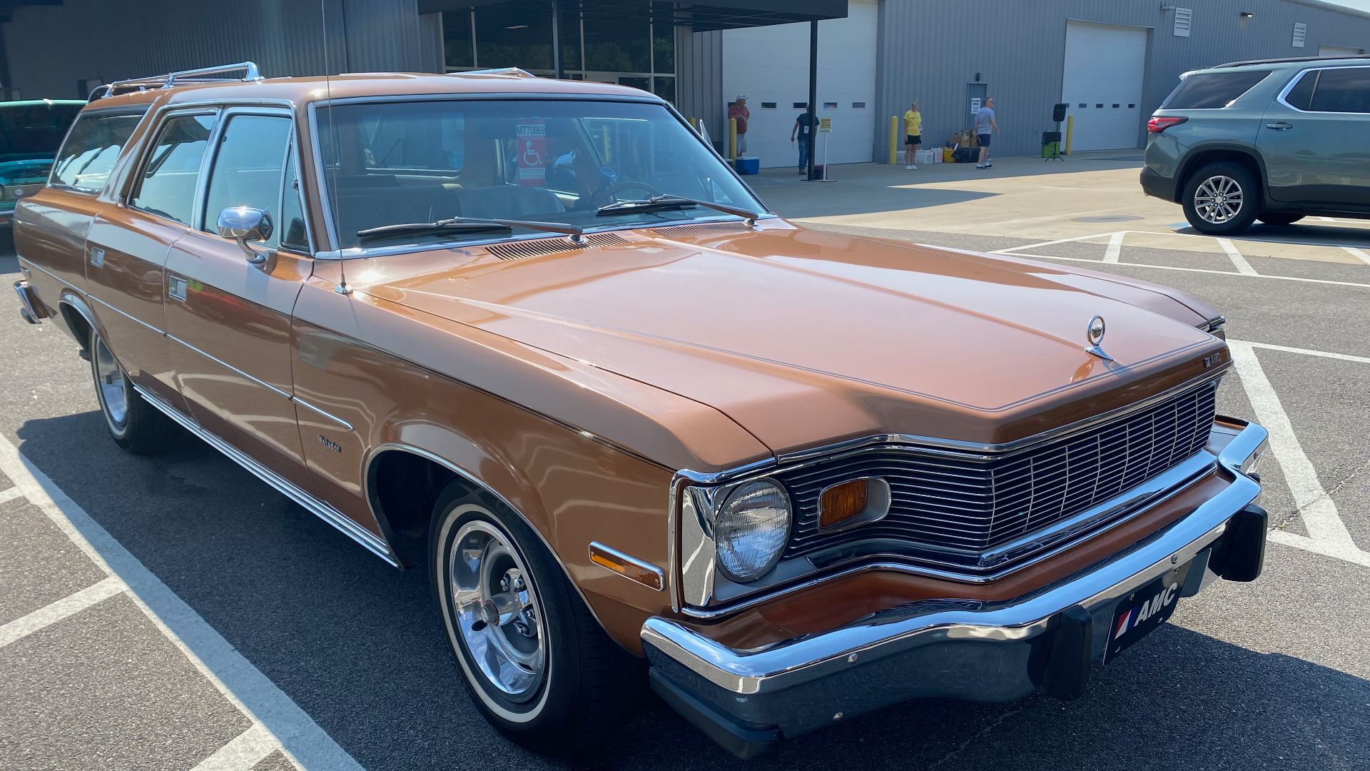 1978 AMC Matador four-door station wagon. All Matadors came with a long list of standard equipment and features. The station wagons offered two- or three-row seats for six or eight passengers. The third row is rear-facing, and all wagons included a two-way tailgate - opening with the rear window retracted as a door hinged on the left side or down on the bottom hinges to extend the load floor. All wagons came with AMC's 360 cu in (5.9 L) V8 engine. This three-row Matador wagon is finished Golden Ginger metallic with a matching interior and has AMC's