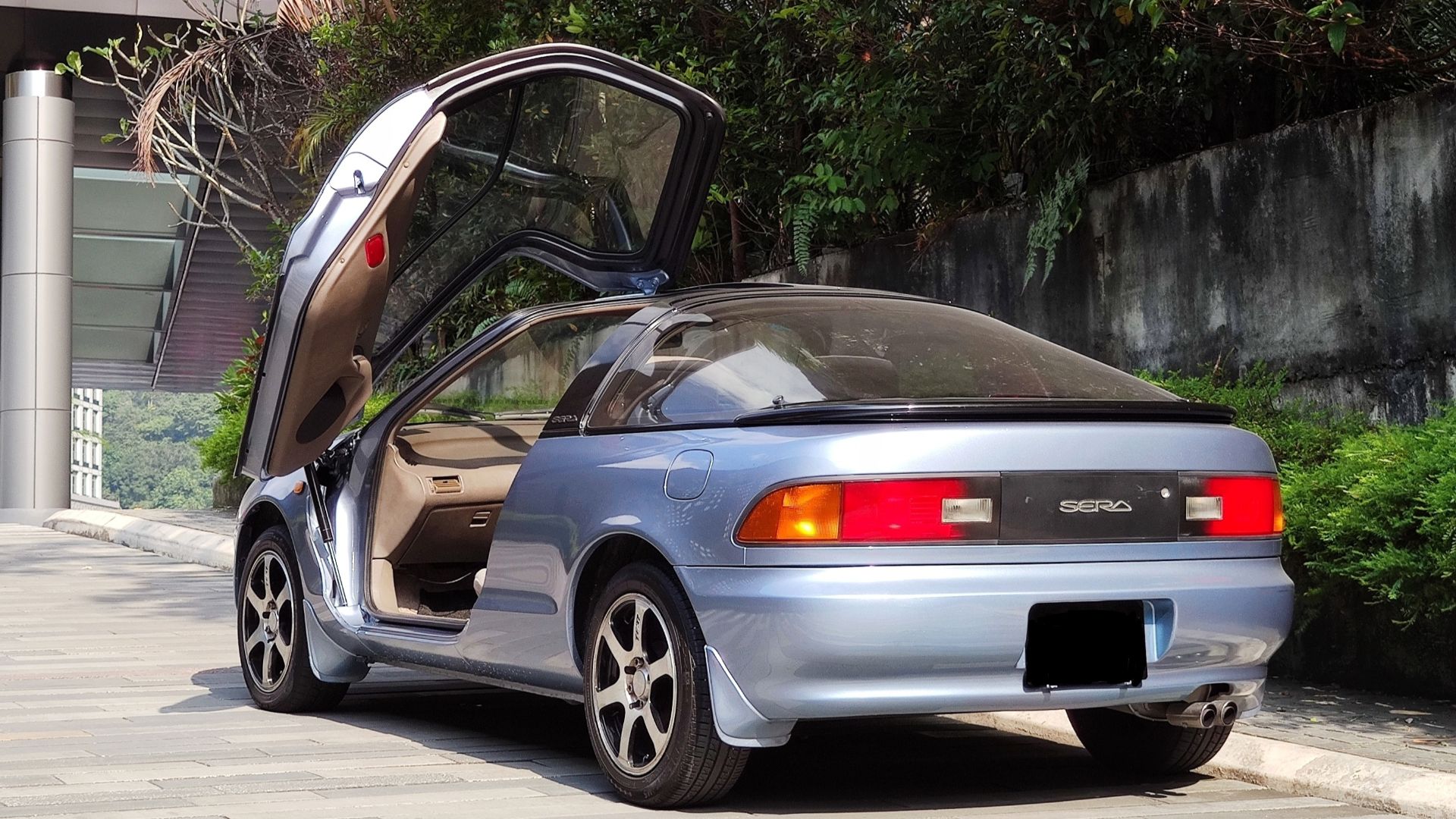 Rear view of Toyota Sera with one butterfly door opened up