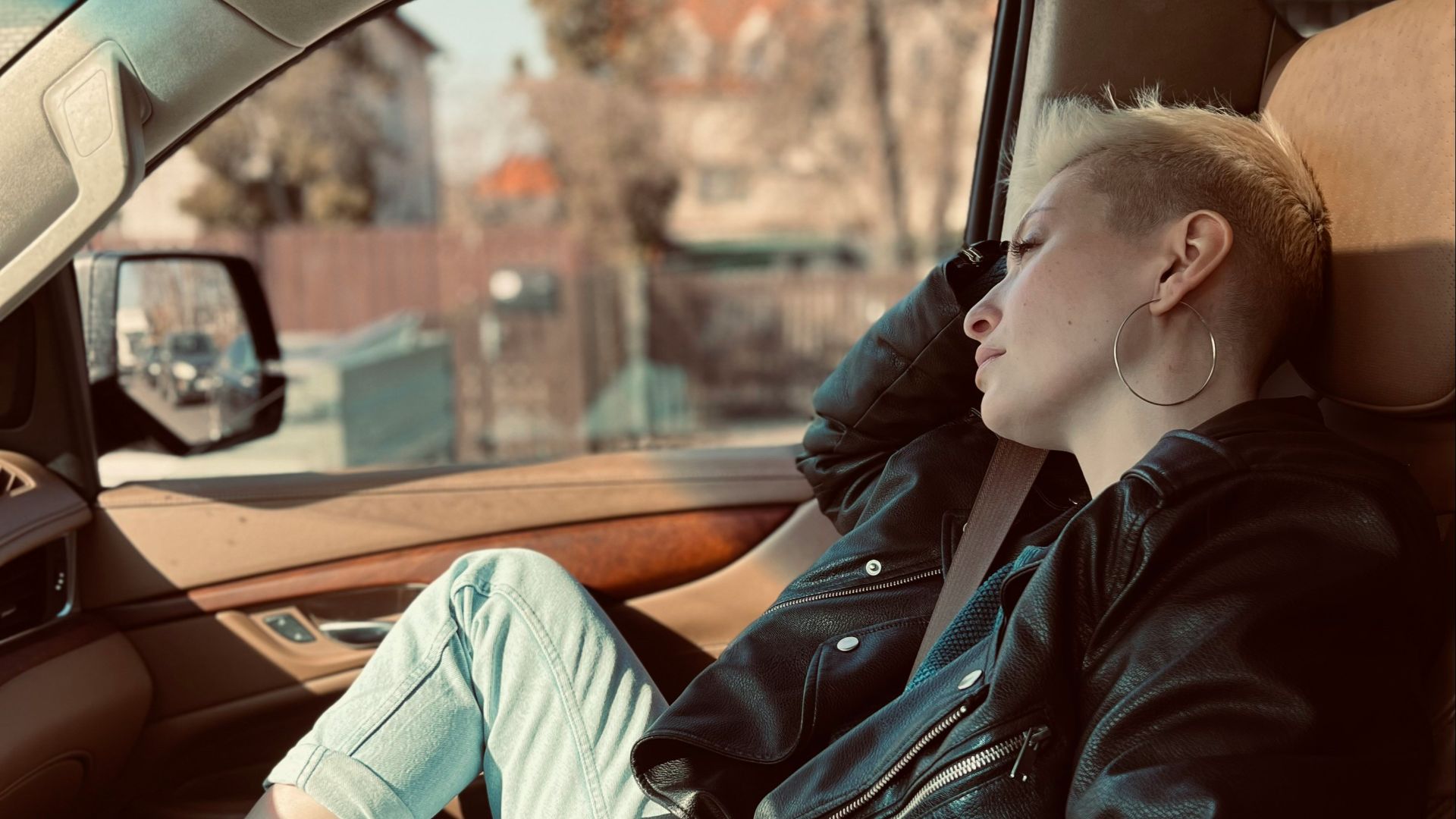 a woman sitting in the passenger seat of a car