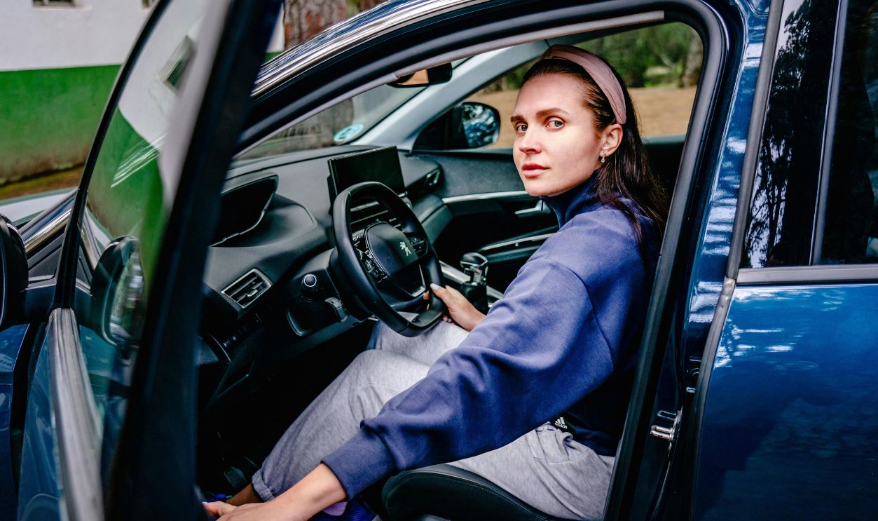 Woman sitting in the driver's seat of a car 