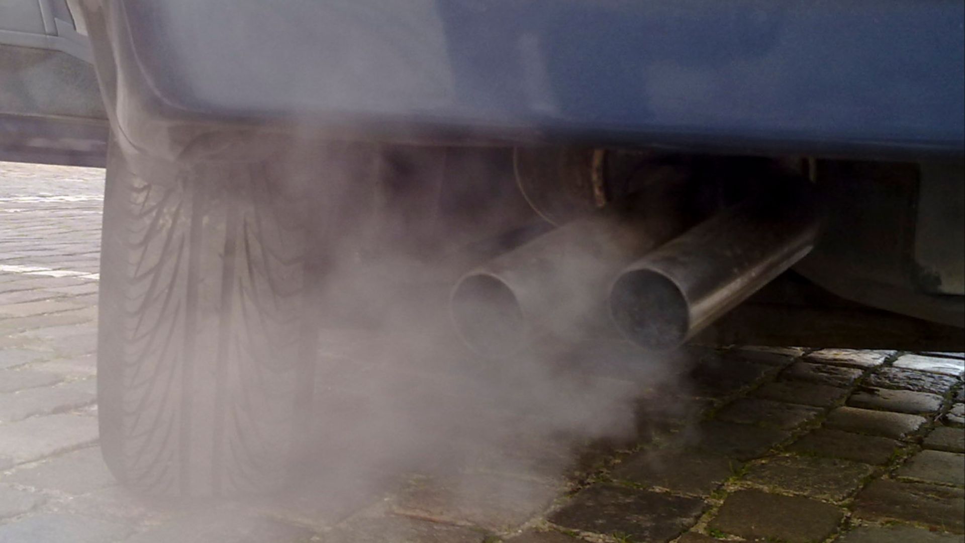 Automobile exhaust gas. White exhaust gas is mostly water vapor. Black smoke could come from oil burning.