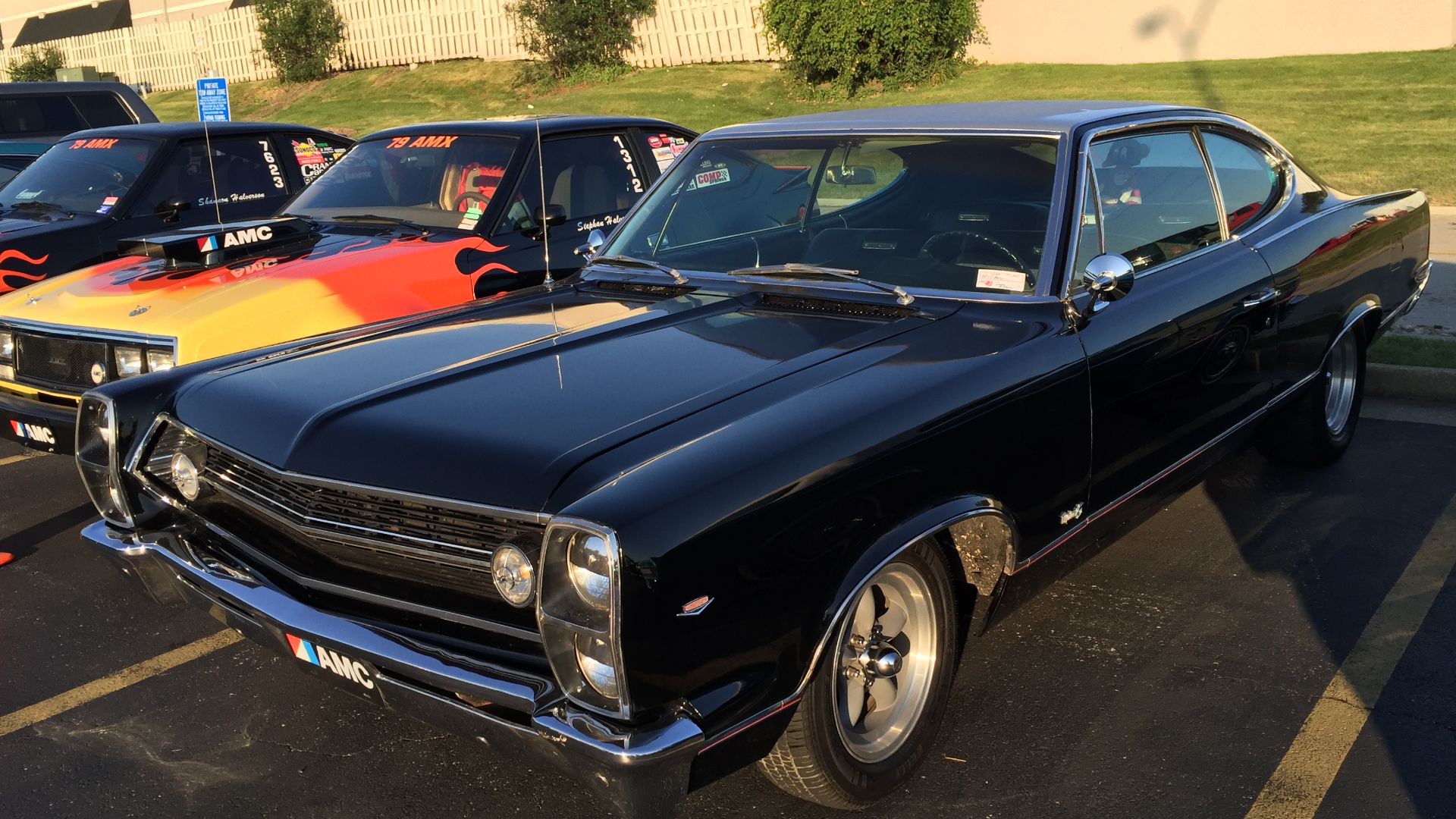 1967 AMC Marlin fastback, a full-sized personal luxury car built by American Motors Corporation. Finished in two-tone black and silver, this car has aftermarket wheels, custom pin striping, as well as the hood and cowl panel from a 1968 Ambassador that ha
