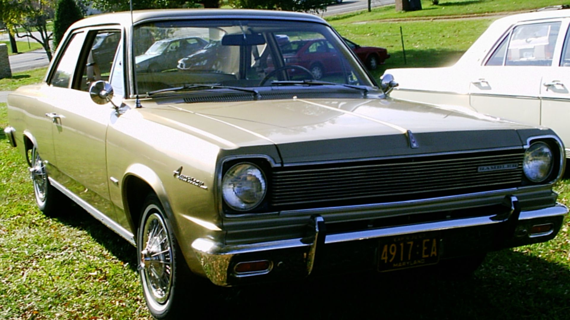 1967 Rambler American 220 by American Motors Corporation (AMC). This two-door sedan has AMC's optional wire wheel covers.