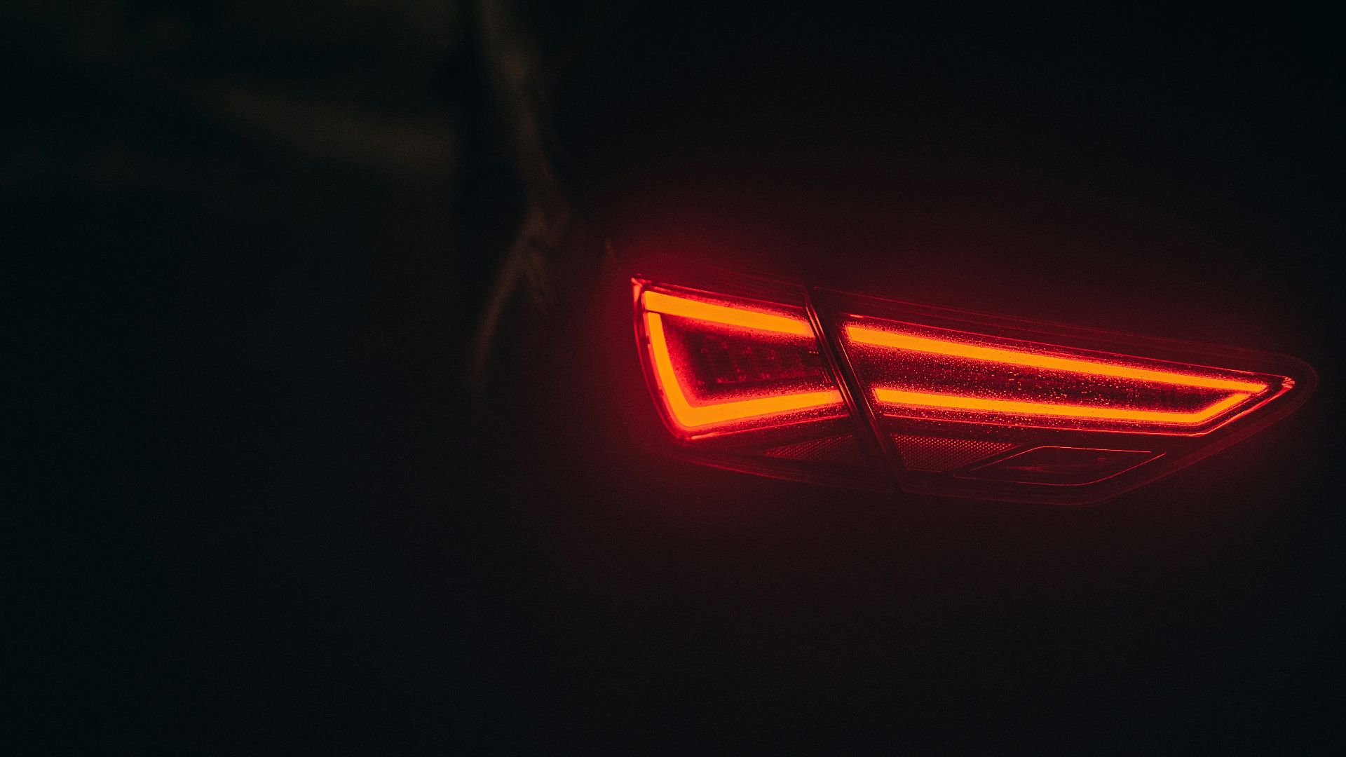 the tail light of a car in the dark