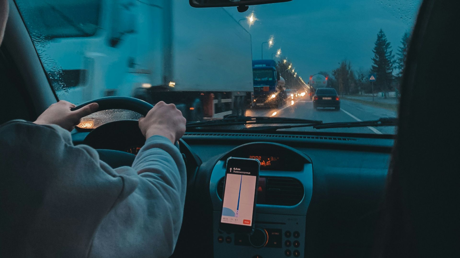 person in gray long sleeve shirt driving car