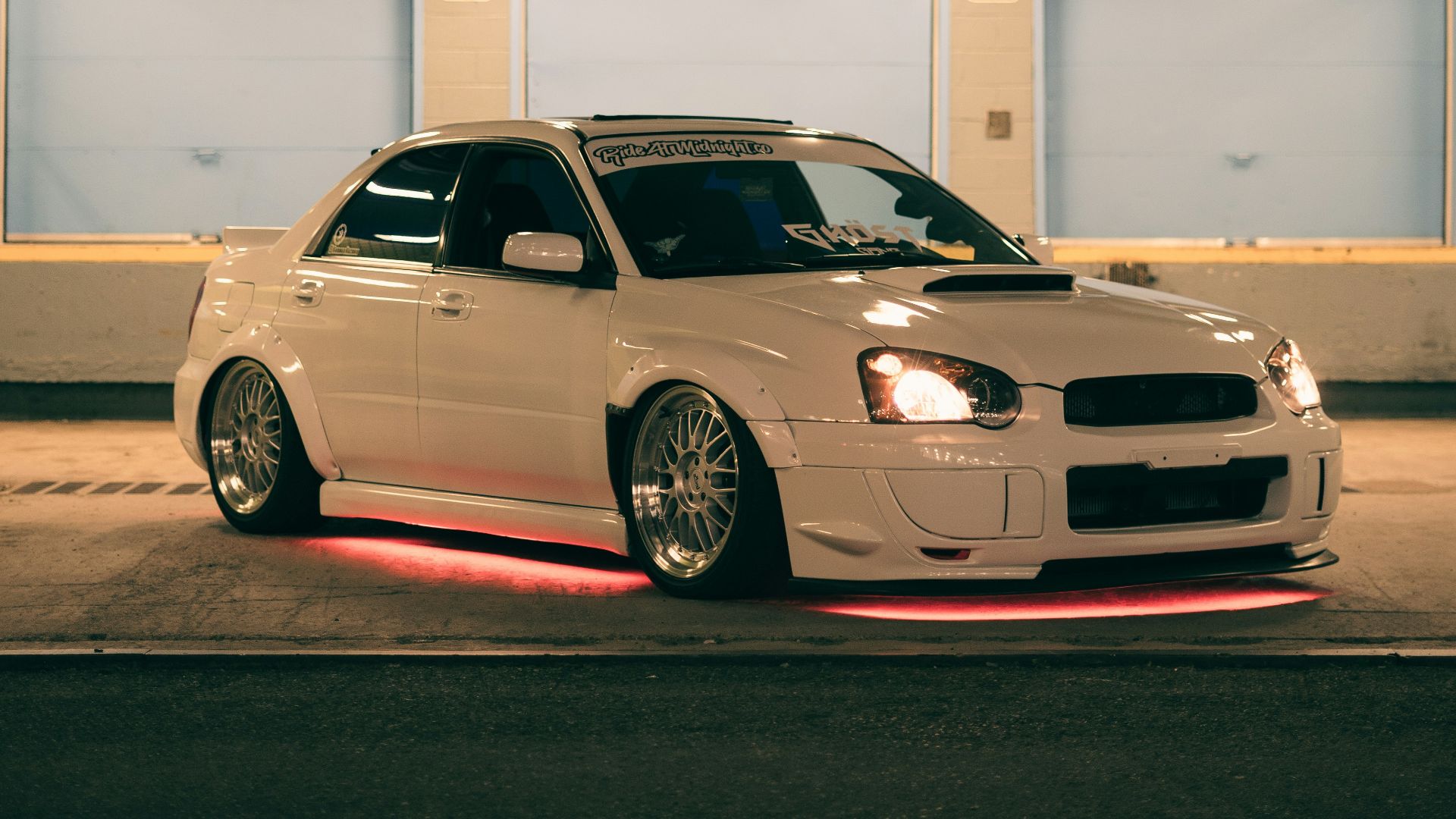 a white car parked in a parking garage