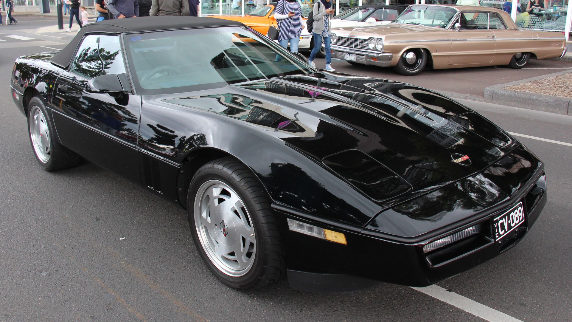Black. 
The C4 Corvette was made from 1984 to 1996. a more sleek modern looking car with a new glass hatchback. Available in Coupe and the Convertible was reintroduced in 1986
Unlike earlier Corvettes, visually, the C4 changed very little through the year