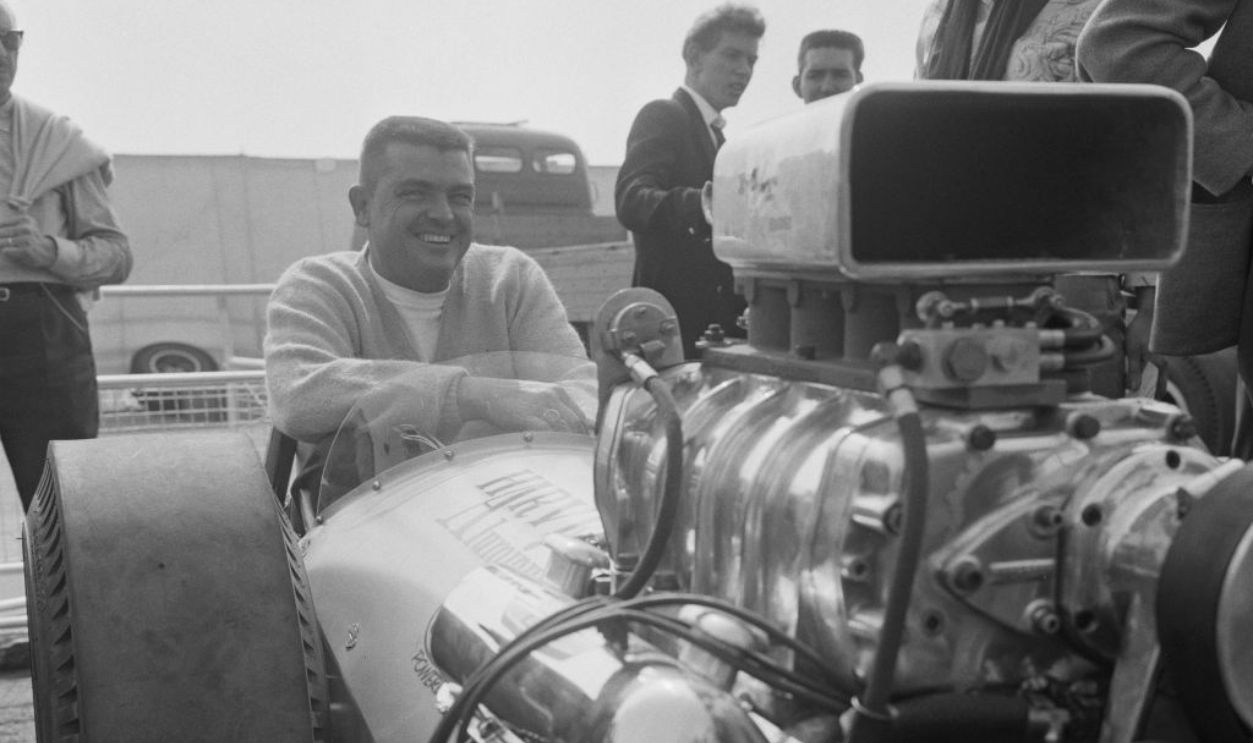 American race car driver and dragster Mickey Thompson (1928-1988) pictured in the driver's seat of the Ford powered Harvey Aluminum dragster during a demonstration event in England on 16th September 1963. 