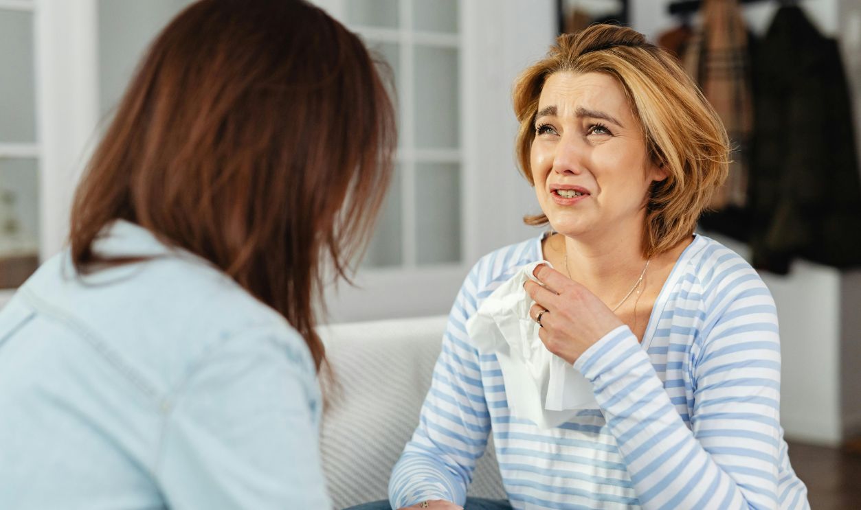 A woman receiving comfort from a friend, illustrating empathy and support in a difficult moment