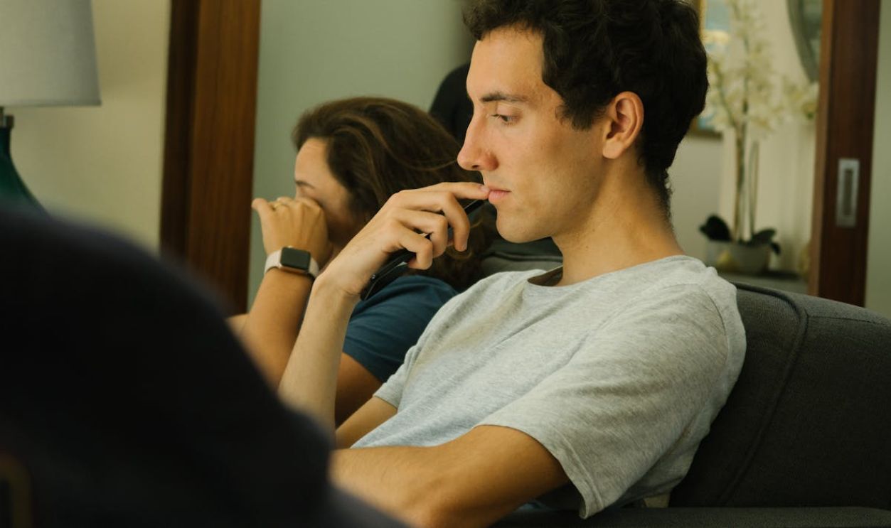 Two people sitting indoors, deep in thought and contemplation