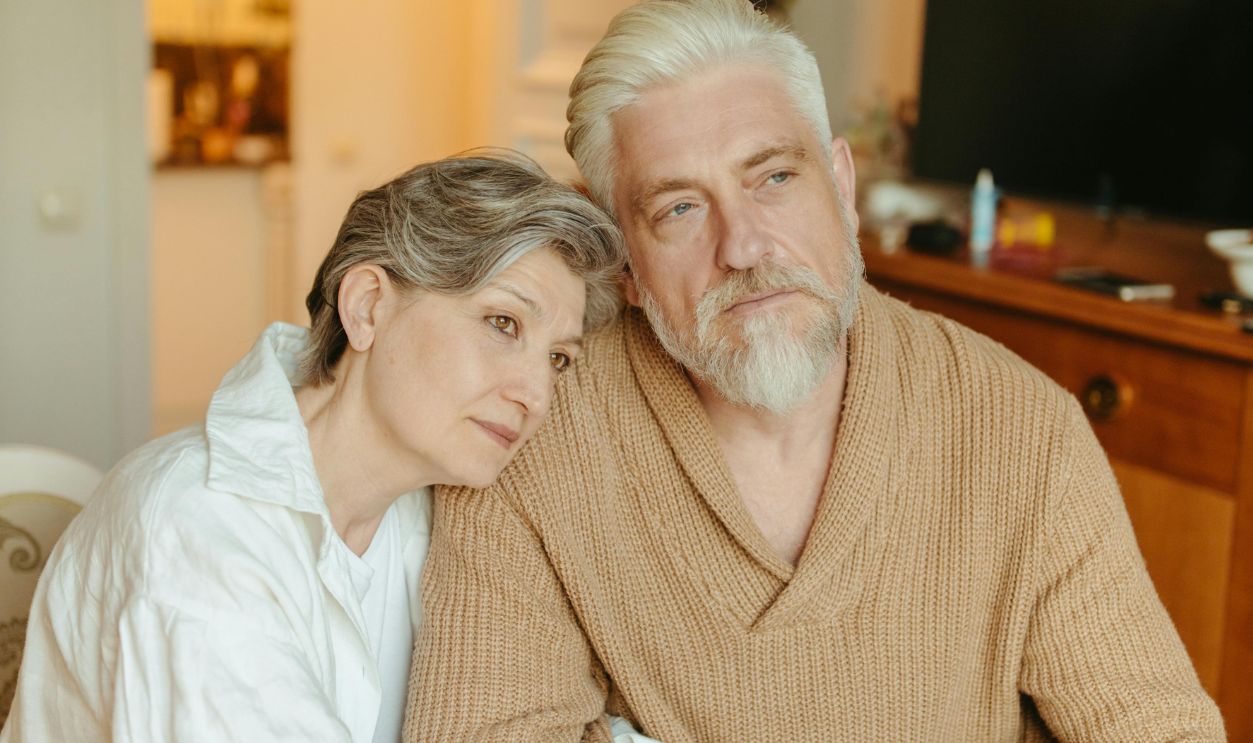Elderly couple sharing a tender moment at home, symbolizing love and companionship