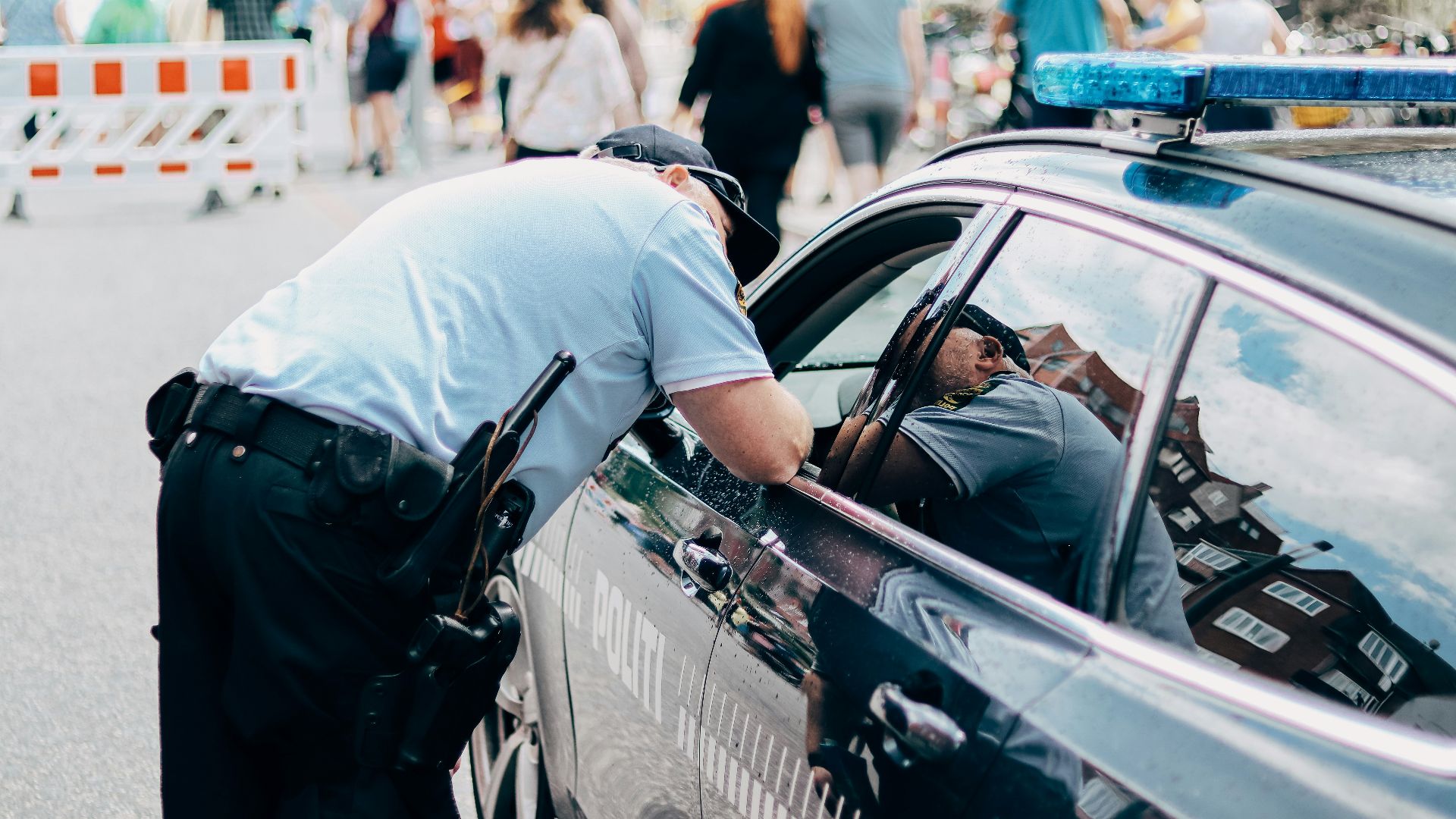 a police officer leaning into a police car