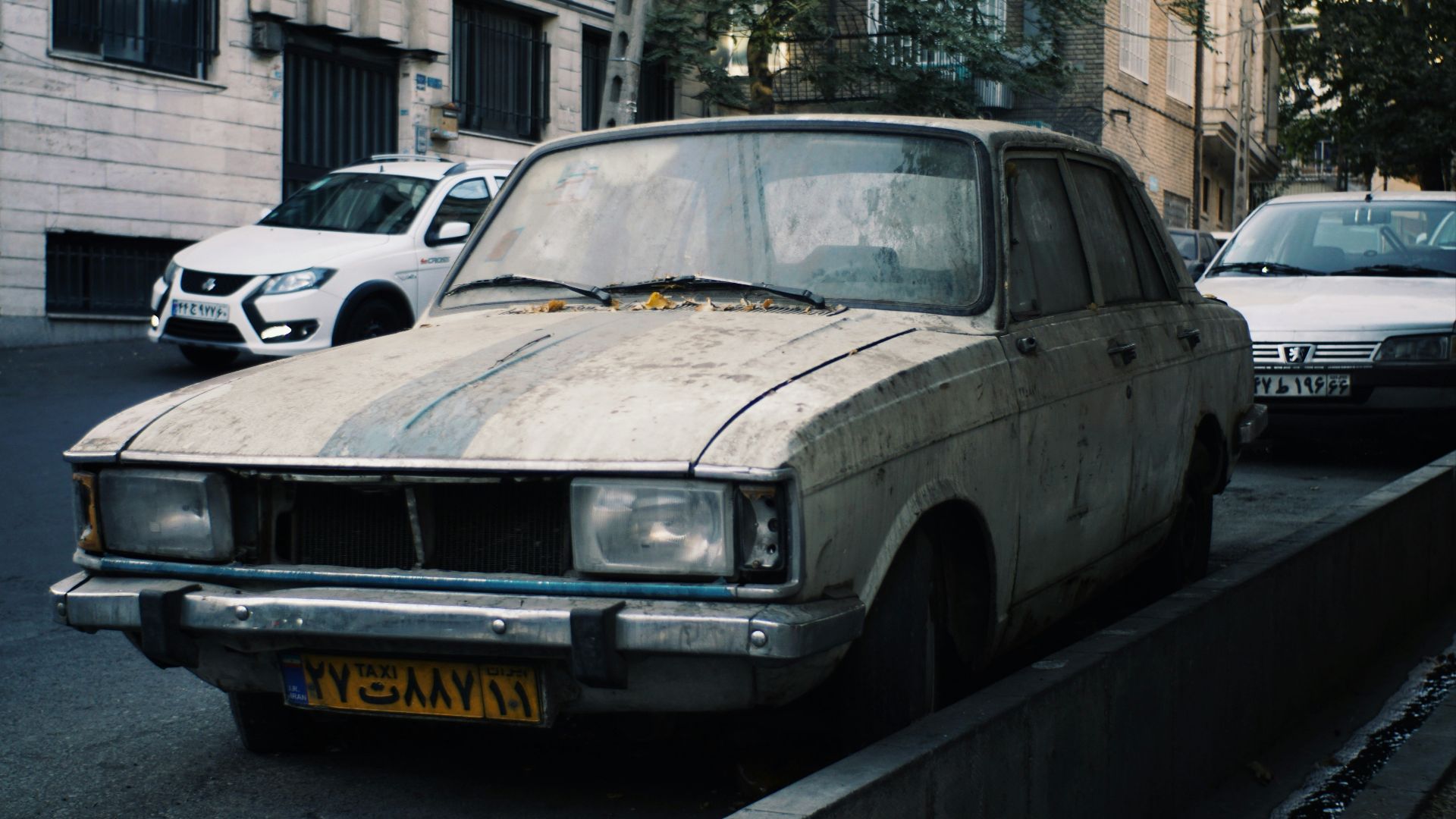 Old car parked on a city street