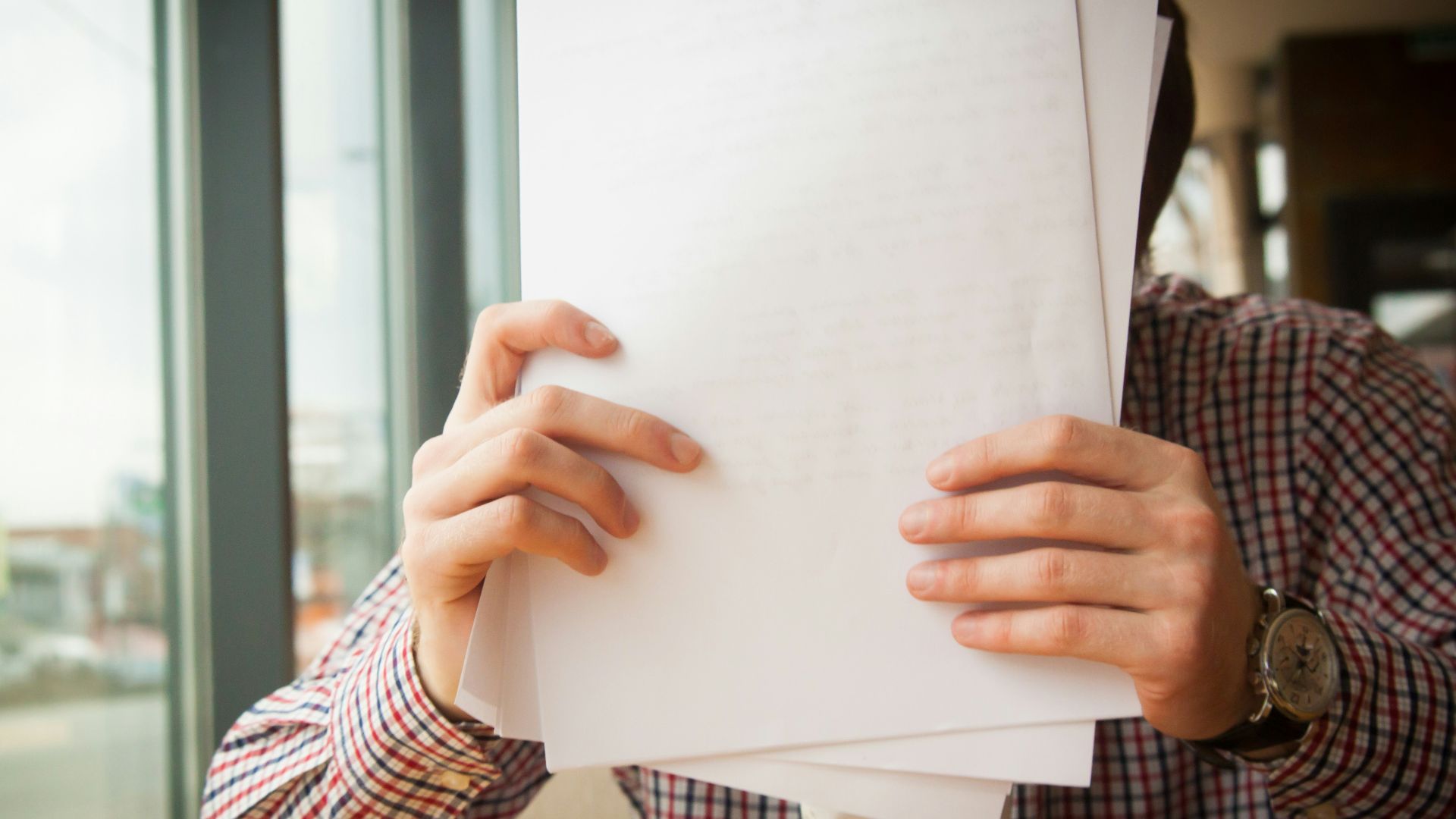 person holding white printer paper