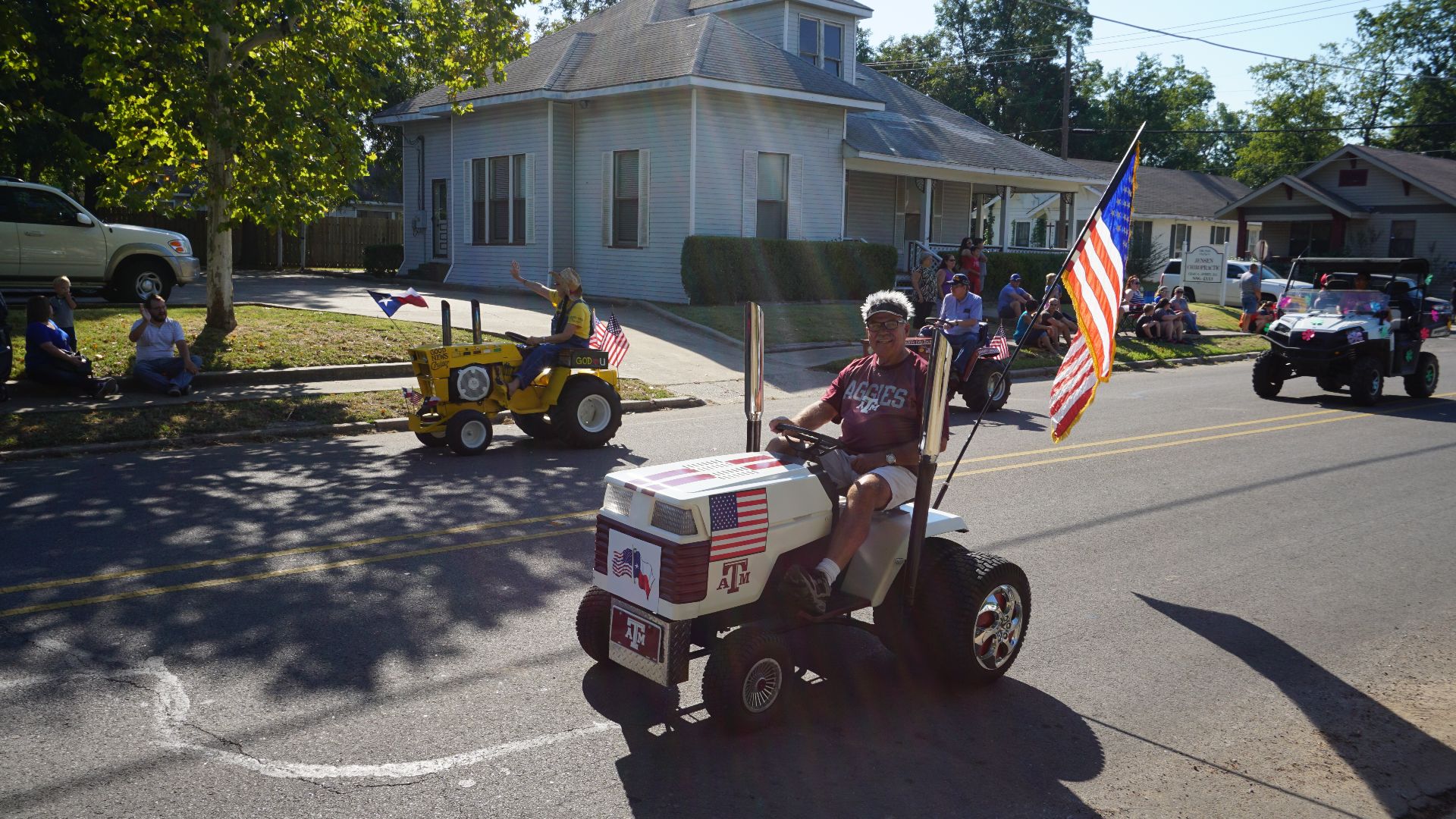 Racing lawn mowers in the parade at the 30th Annual Bois d'Arc Bash in Commerce, Texas (United States).