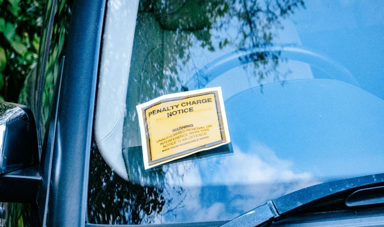 Close-up of a ticket held near a car window