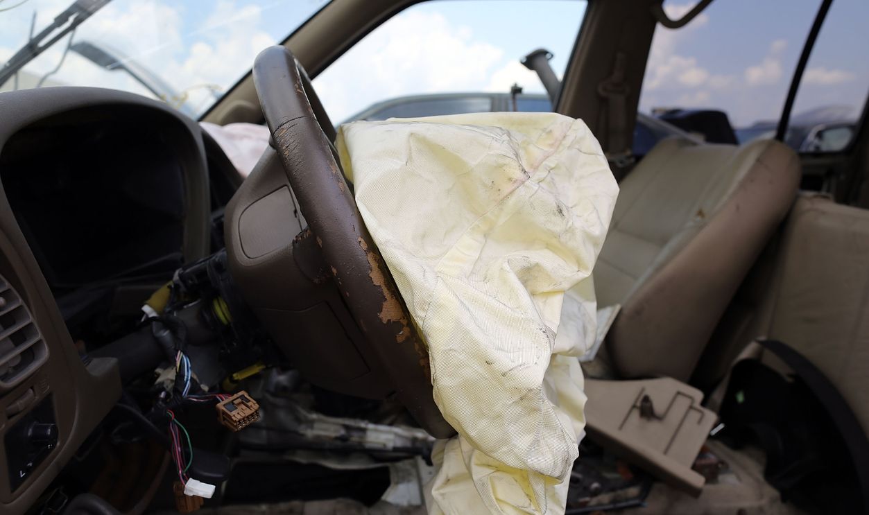 A deployed airbag is seen in a Nissan vehicle at the LKQ Pick Your Part salvage yard on May 22, 2015 in Medley, Florida. The largest automotive recall in history centers around the defective Takata Corp. air bags that are found in millions of vehicles that are manufactured by BMW, Chrysler, Daimler Trucks, Ford, General Motors, Honda, Mazda, Mitsubishi, Nissan, Subaru and Toyota. 