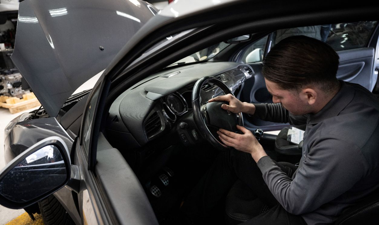 A mechanic installs a new airbag module in a car after removing an airbag module made by the Japanese airbag manufacturer Takata, in a garage in Mulhouse, eastern France, on February 19, 2025. Some 236,900 Citroën C3 and DS 3 cars' owners in northern France were asked on February 18, 2025 not to drive their cars until their airbags had been replaced, as part of a new wave of immobilisations linked to the Takata scandal.