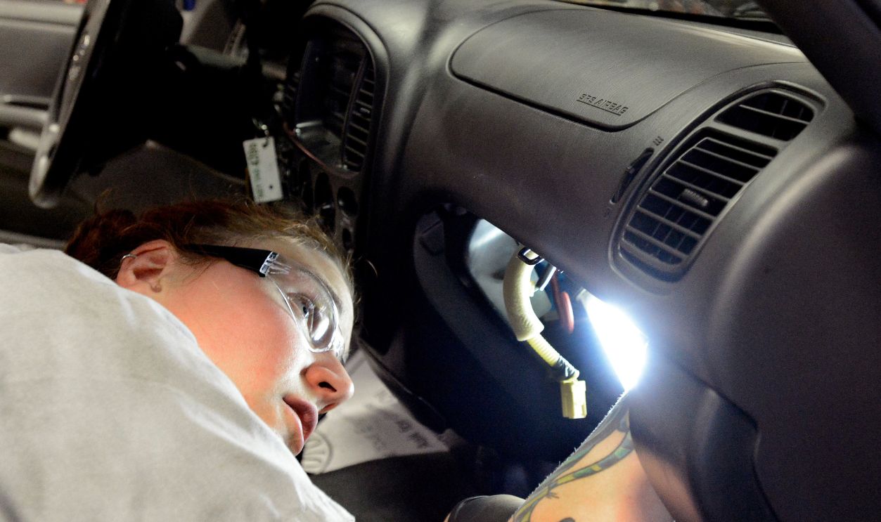 Japanese auto supplier Takata has issued recalls for 34 million airbags. Auto tech Becky McInnis reinstalls a airbag after changing the inflator module on this 03 Toyota Tundra at Lee Toyota in Topsham.