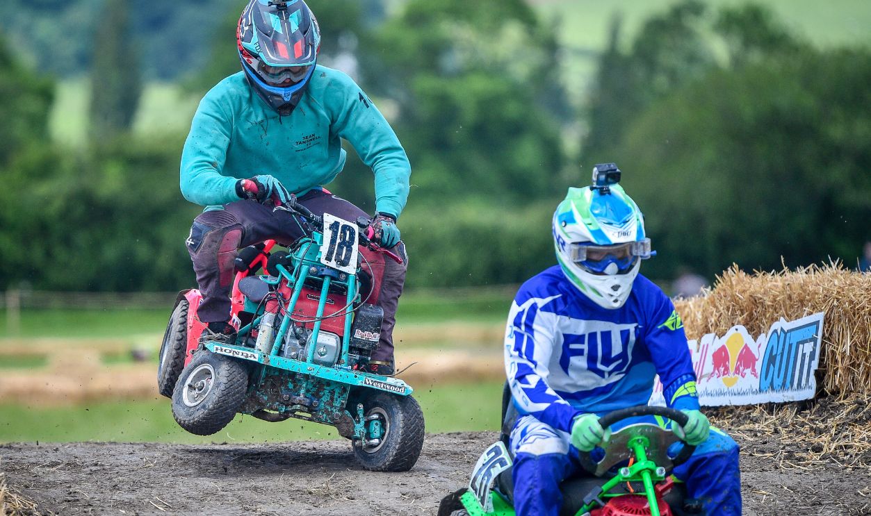 Competitors battle it out during the Red Bull Cut It, lawn mower racing event, where participants reach speeds of up to 50mph on modified ride-on lawnmowers as they navigate their way around four separate courses at Chestnut House, in Lower Weare, Axbridge. 