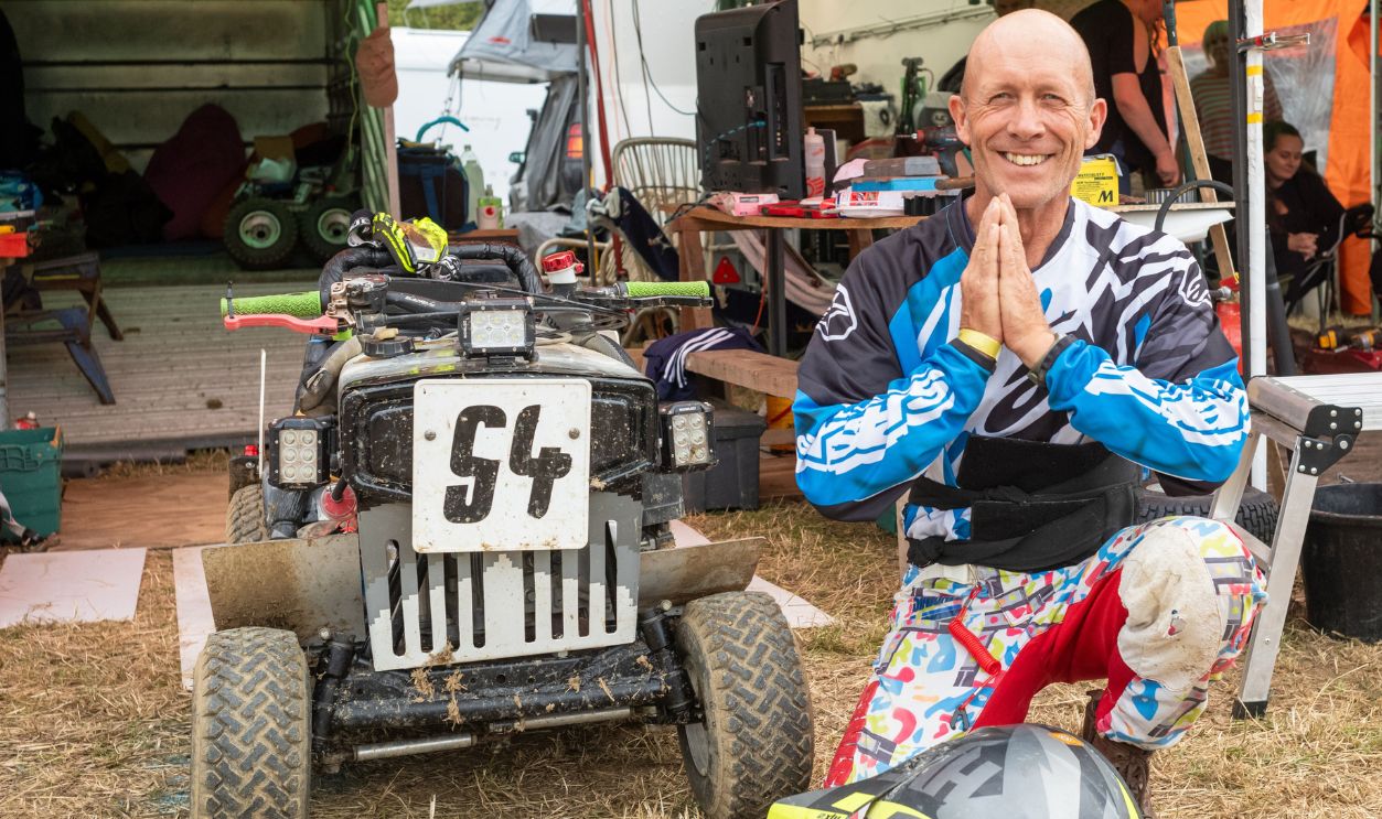 Leon Clark, a racing lawn mower driver kneels next to his racing mower to pray for success before the BLMRA 500, a Le Mans style 500 mile overnight lawn mower race in a field in West Sussex, UK. The British Lawn Mower Racing Association is holding its 50th anniversary 12 hour race overnight Saturday/Sunday with 52 teams, each with up to three drivers.
