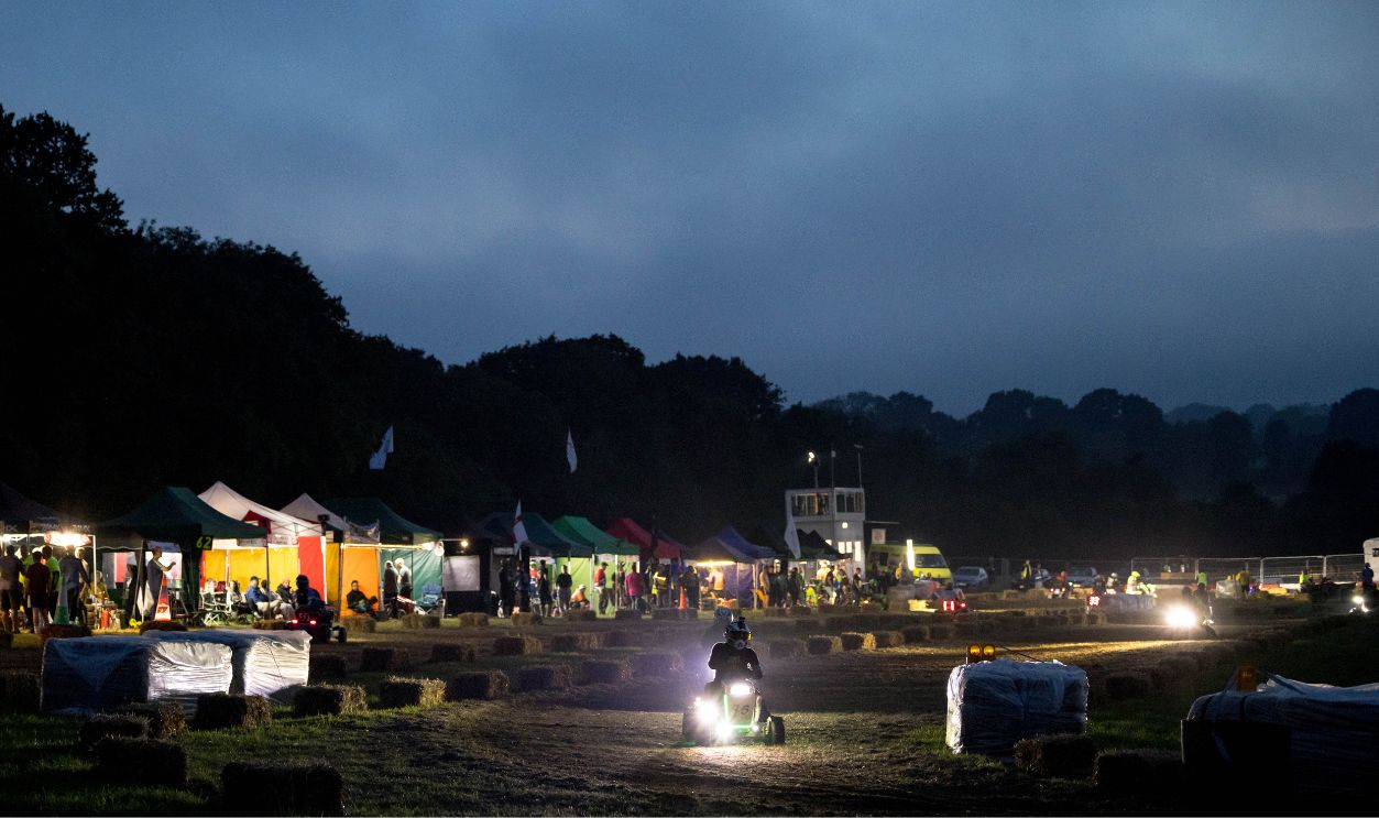 A driver takes part in an overnight lawn mower race at the Trooper Inn Field on August 10, 2024 in Petersfield, England. The 12-hour endurance race runs from 8 PM to 8 AM and see 45 teams compete on a 1.1km dirt track. According to the British Lawn Mower Racing Association, the sport was born in 1973 by an Irishman named Jim Gavin in West Sussex, who was having a few pints with his mates while watching a groundsman mow a cricket pitch.