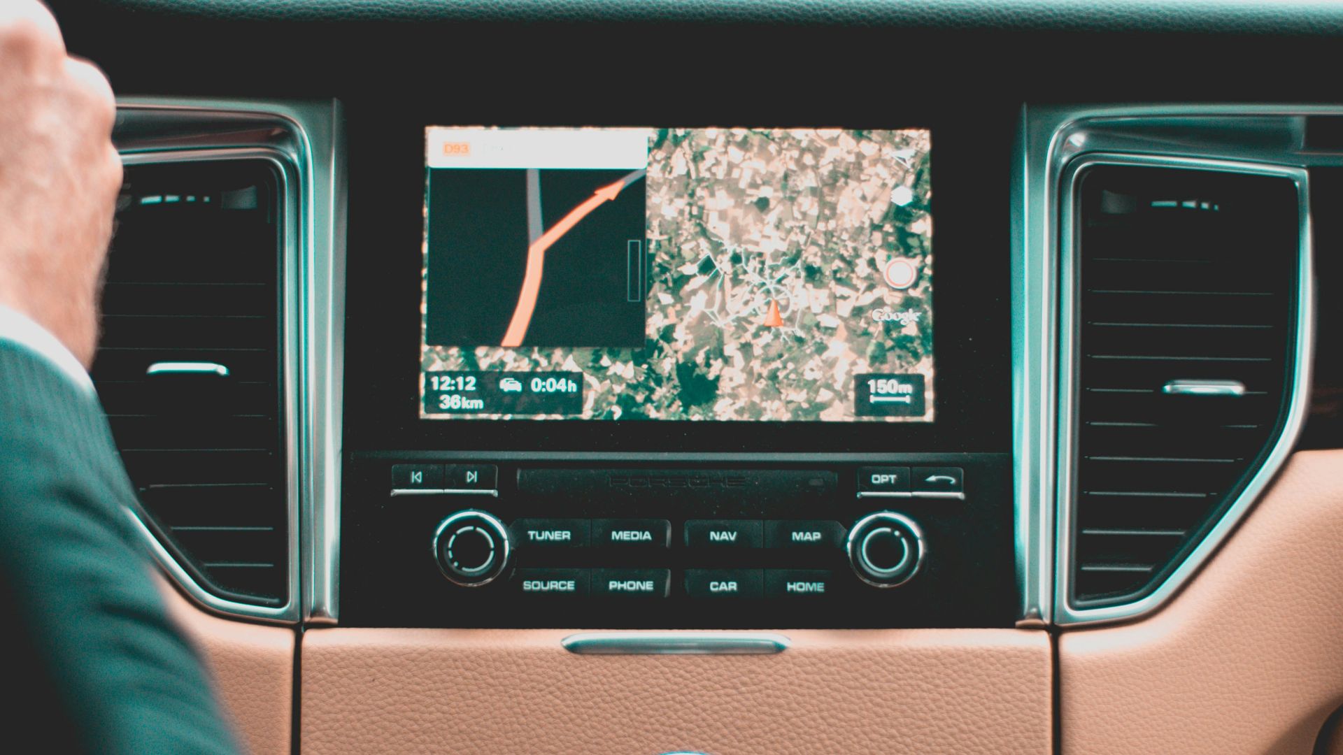 person holding steering wheel